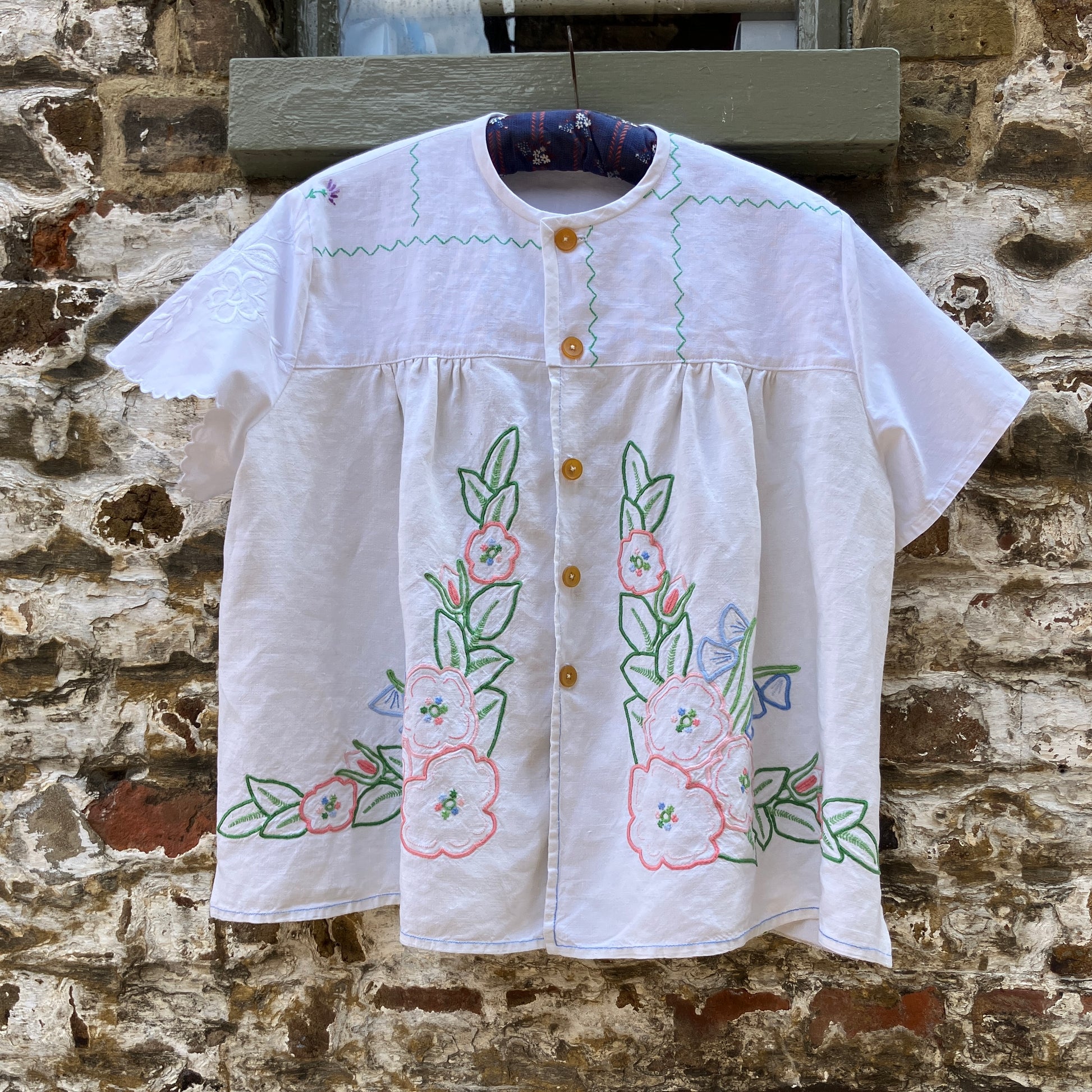 Swingy top made from found repurposed vintage tablecloths with embroidery and cutwork motifs.