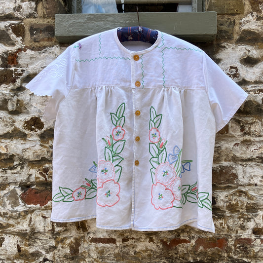 Swingy top made from found repurposed vintage tablecloths with embroidery and cutwork motifs.
