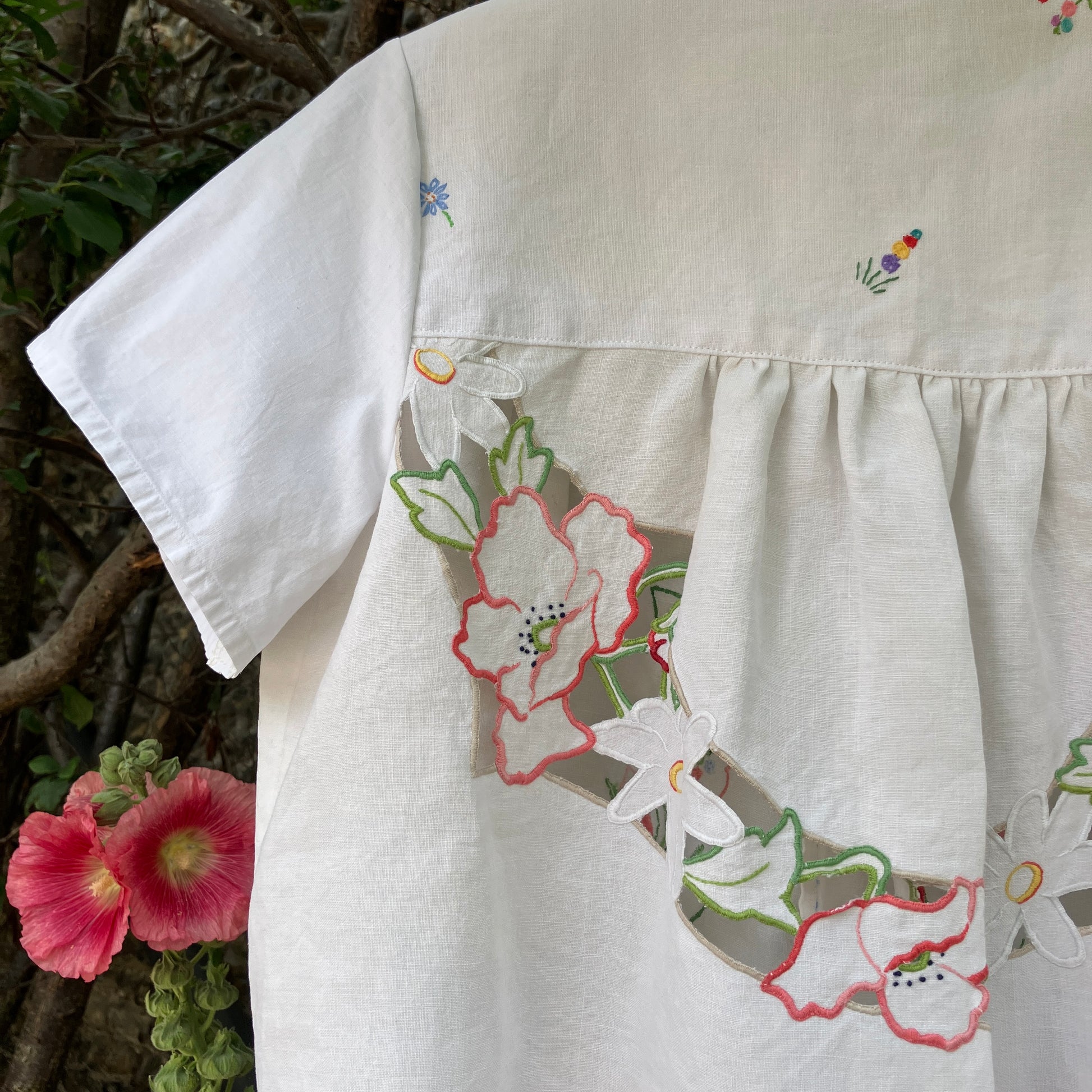 Swingy top made from found repurposed vintage tablecloths with embroidery and cutwork motifs.