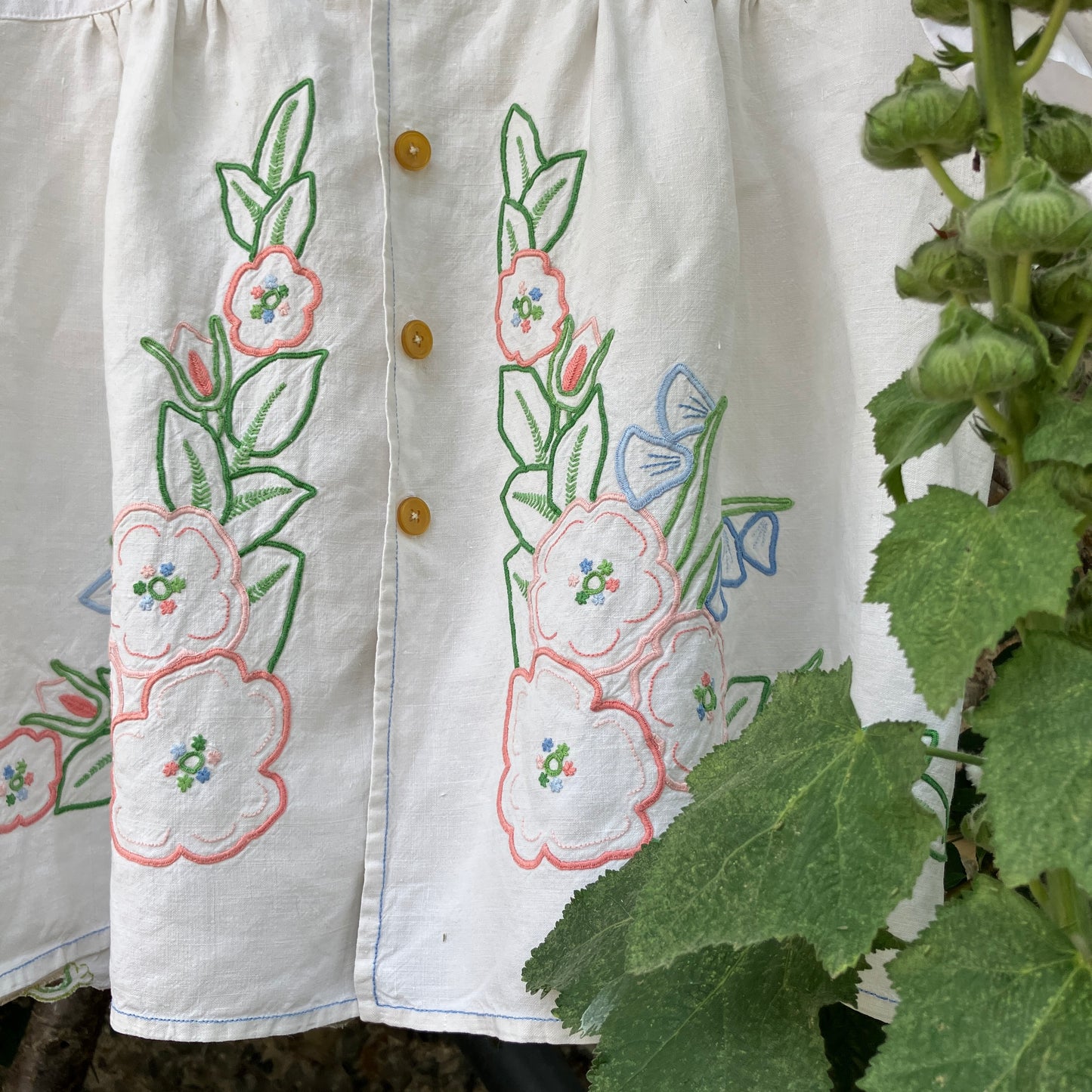 Swingy top made from found repurposed vintage tablecloths with embroidery and cutwork motifs.
