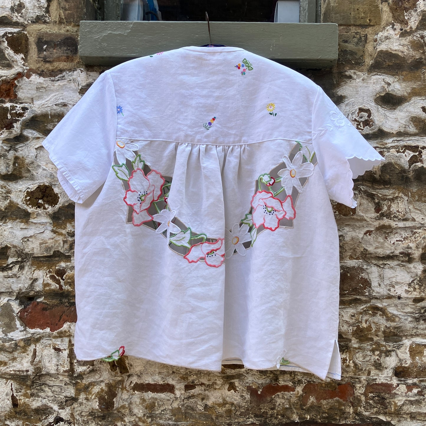 Swingy top made from found repurposed vintage tablecloths with embroidery and cutwork motifs.