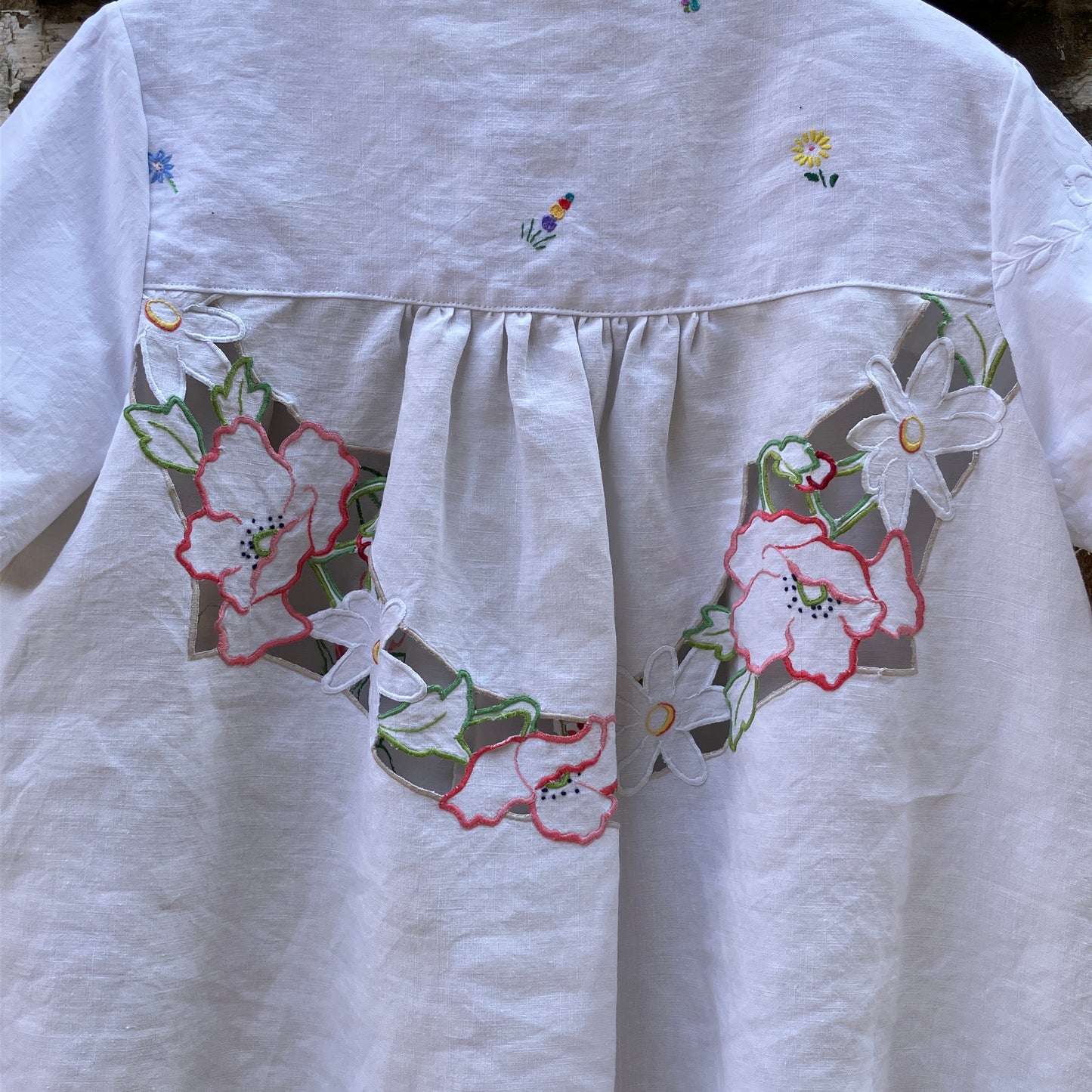 Swingy top made from found repurposed vintage tablecloths with embroidery and cutwork motifs.