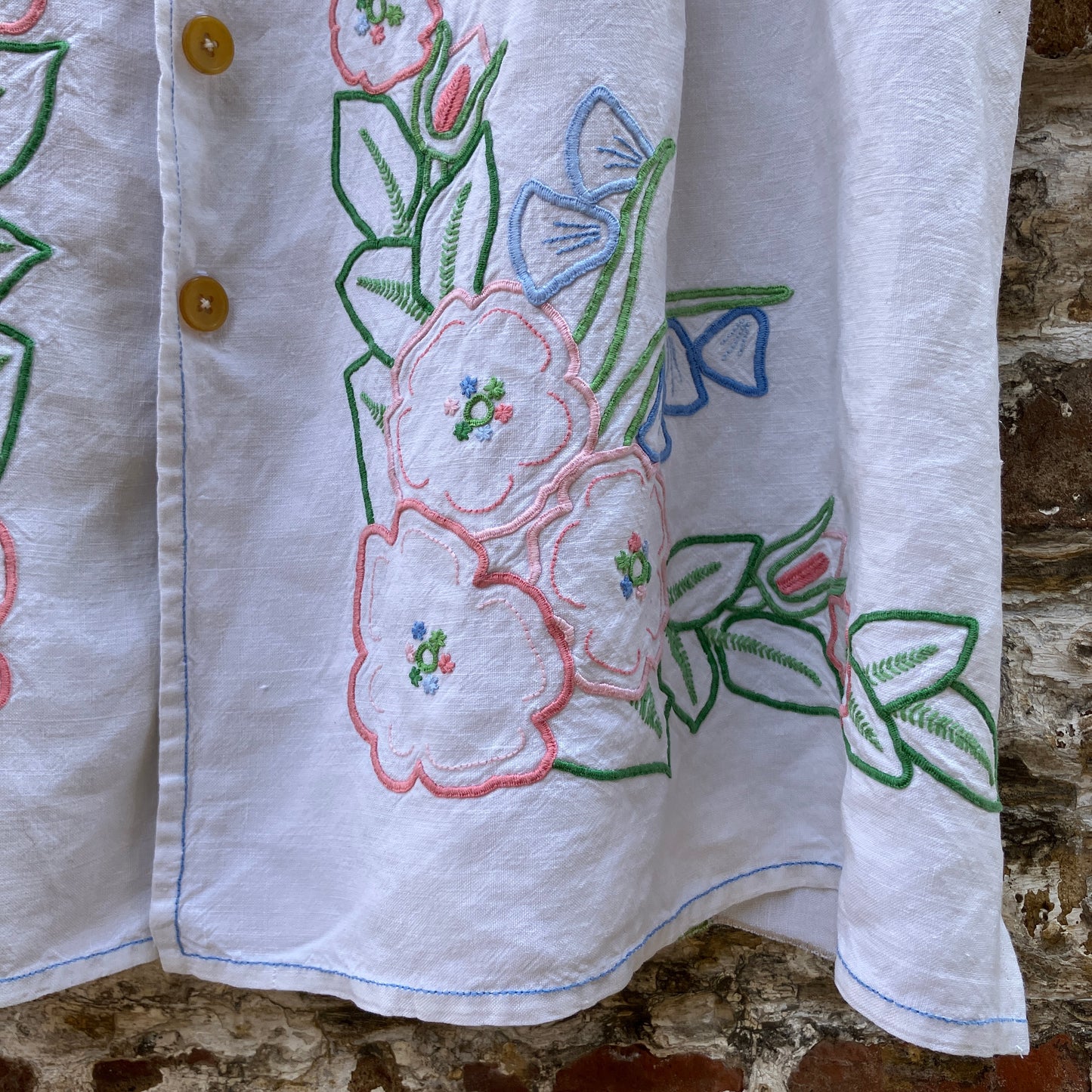 Swingy top made from found repurposed vintage tablecloths with embroidery and cutwork motifs.