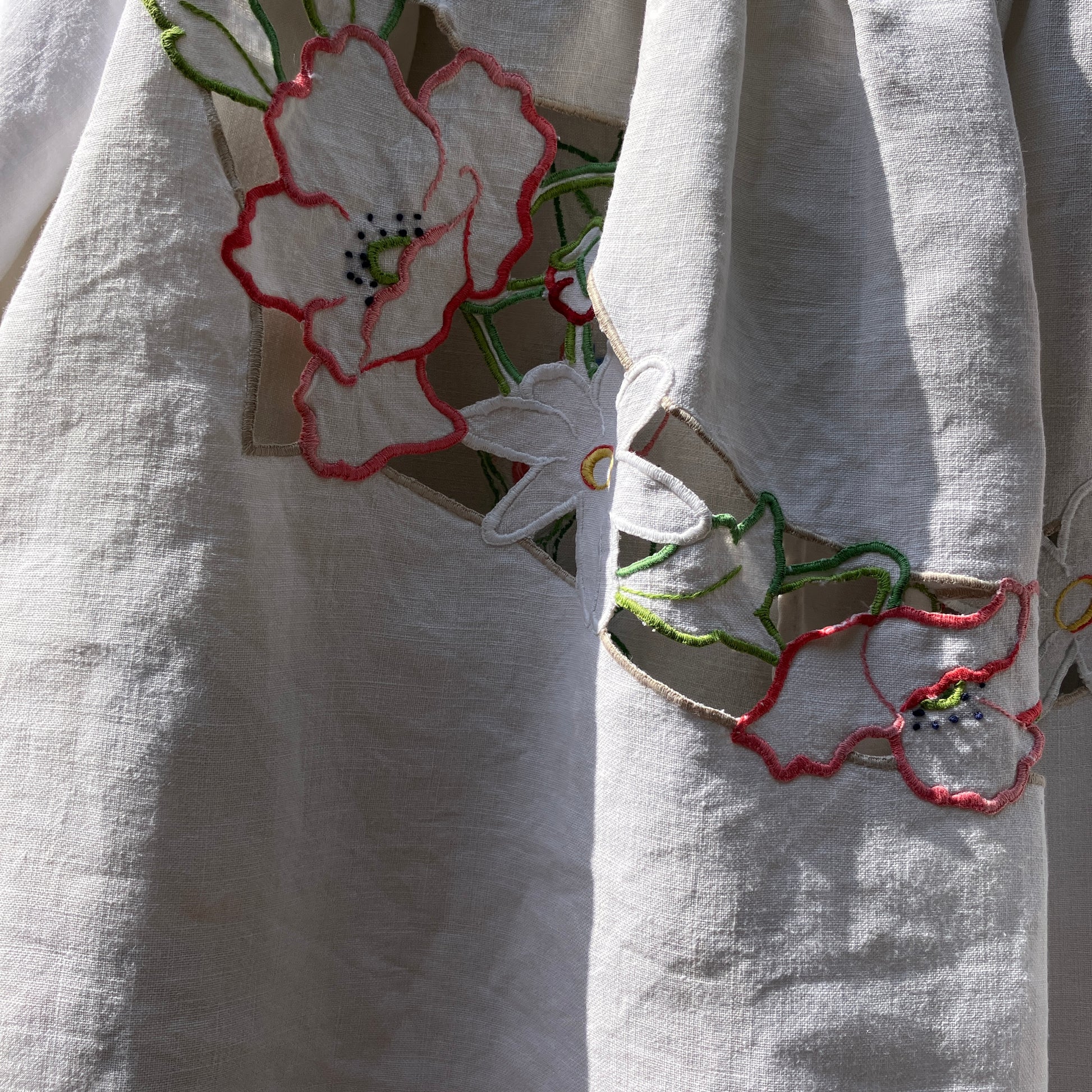 Swingy top made from found repurposed vintage tablecloths with embroidery and cutwork motifs.