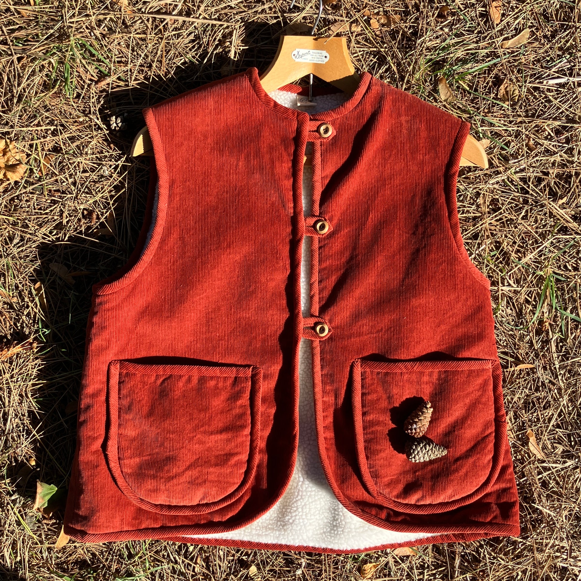 Cosy vest/waistcoat made from a secondhand remnant of rust-coloured corduroy, lined with found faux sheepskin fleece