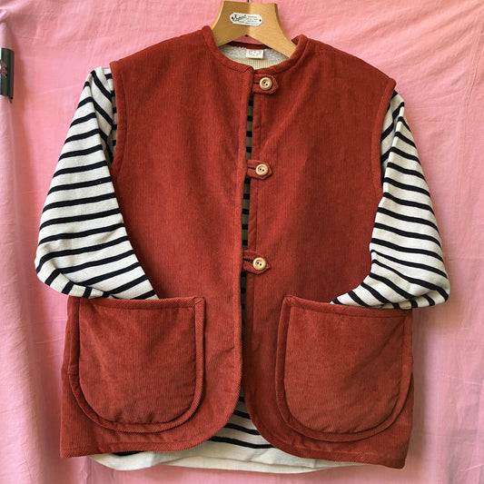Cosy vest/waistcoat made from a secondhand remnant of rust-coloured corduroy, lined with found faux sheepskin fleece