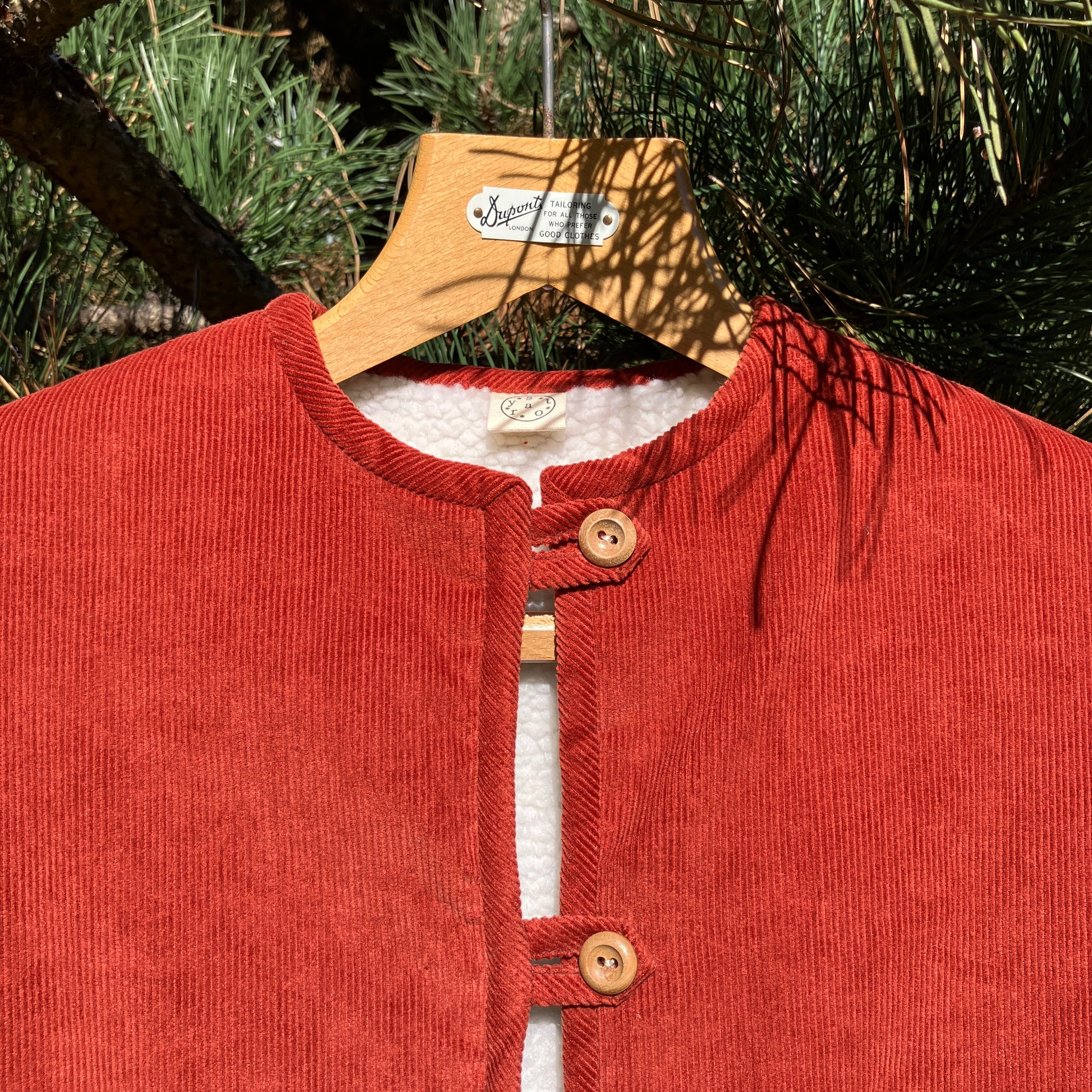 Cosy vest/waistcoat made from a secondhand remnant of rust-coloured corduroy, lined with found faux sheepskin fleece