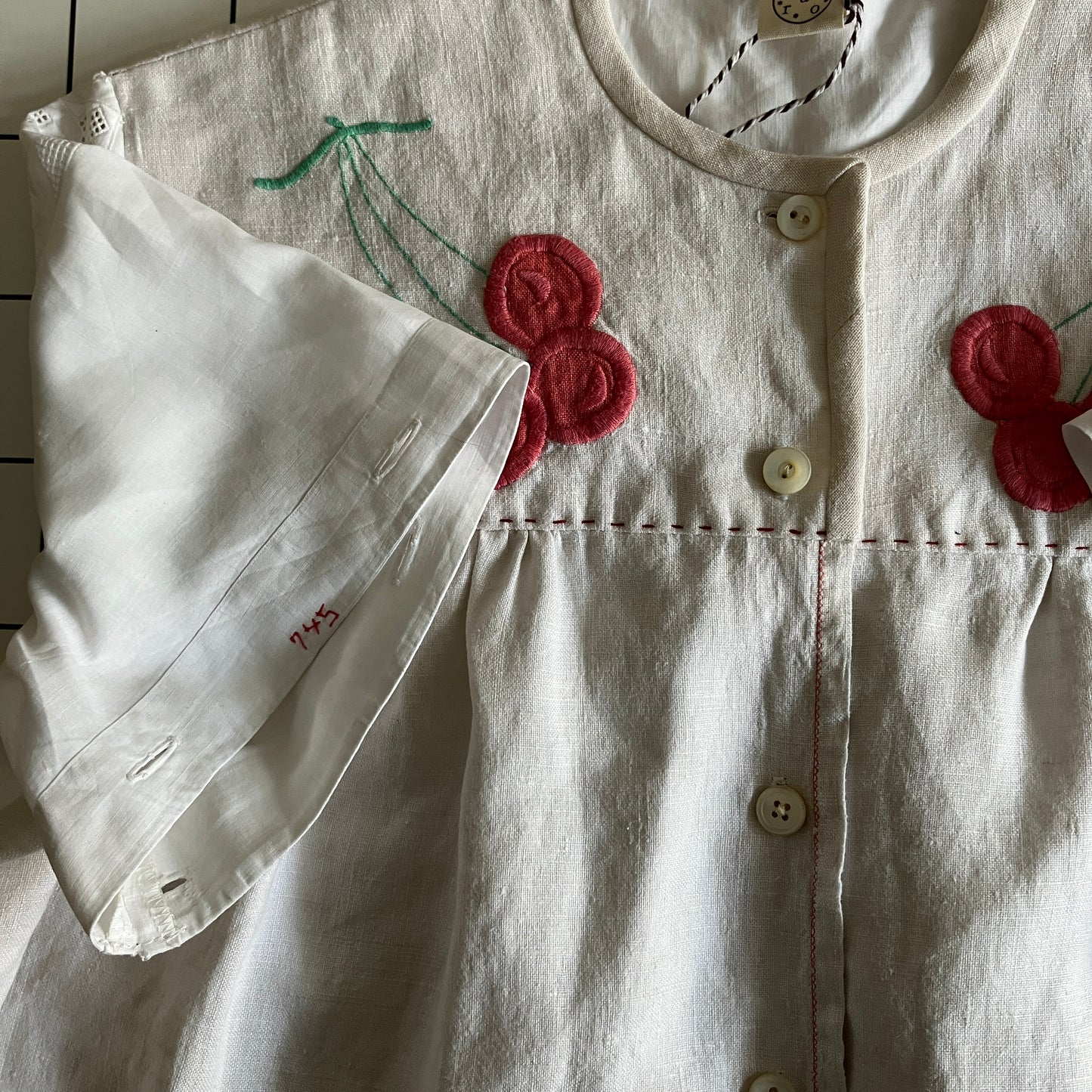 Top made from a patchwork of a recycled linen tablecloth with cherry motifs and antique bed linen