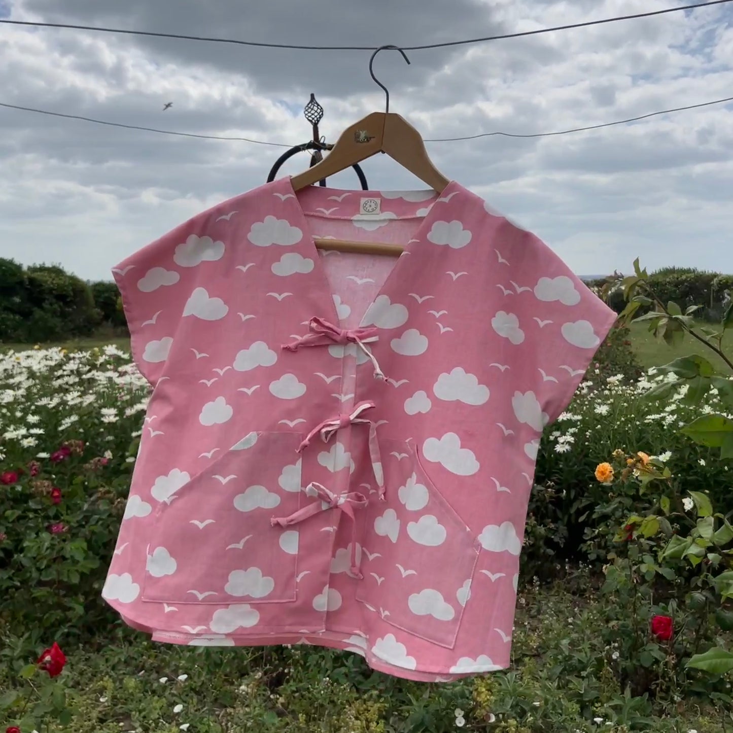 Boxy-fit tie-front top made from a repurposed vintage pink 1980s cloud-print curtain