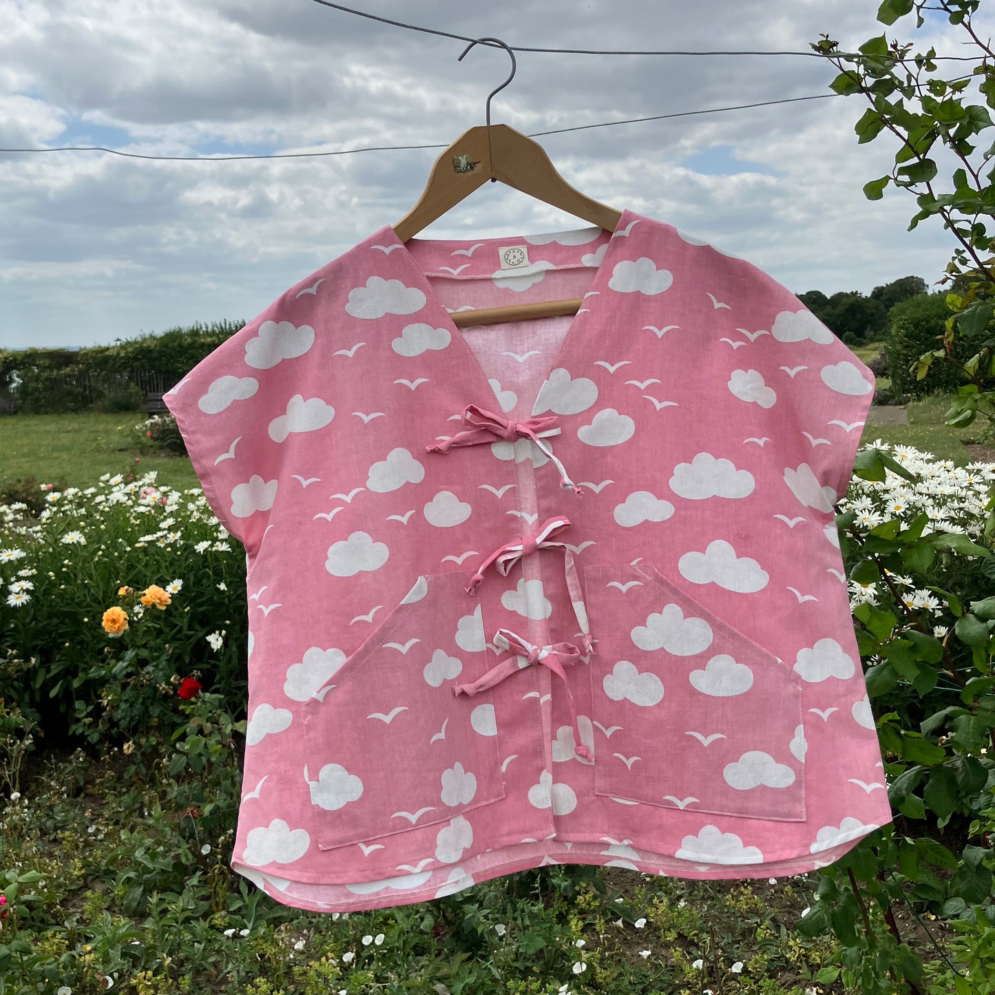 Boxy-fit tie-front top made from a repurposed vintage pink 1980s cloud-print curtain