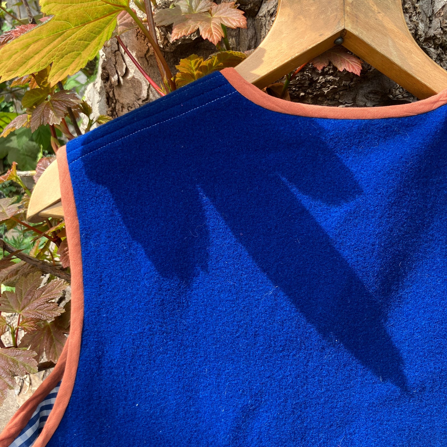 Vest made from a piece of soft cobalt blue wool, lined with cotton gingham