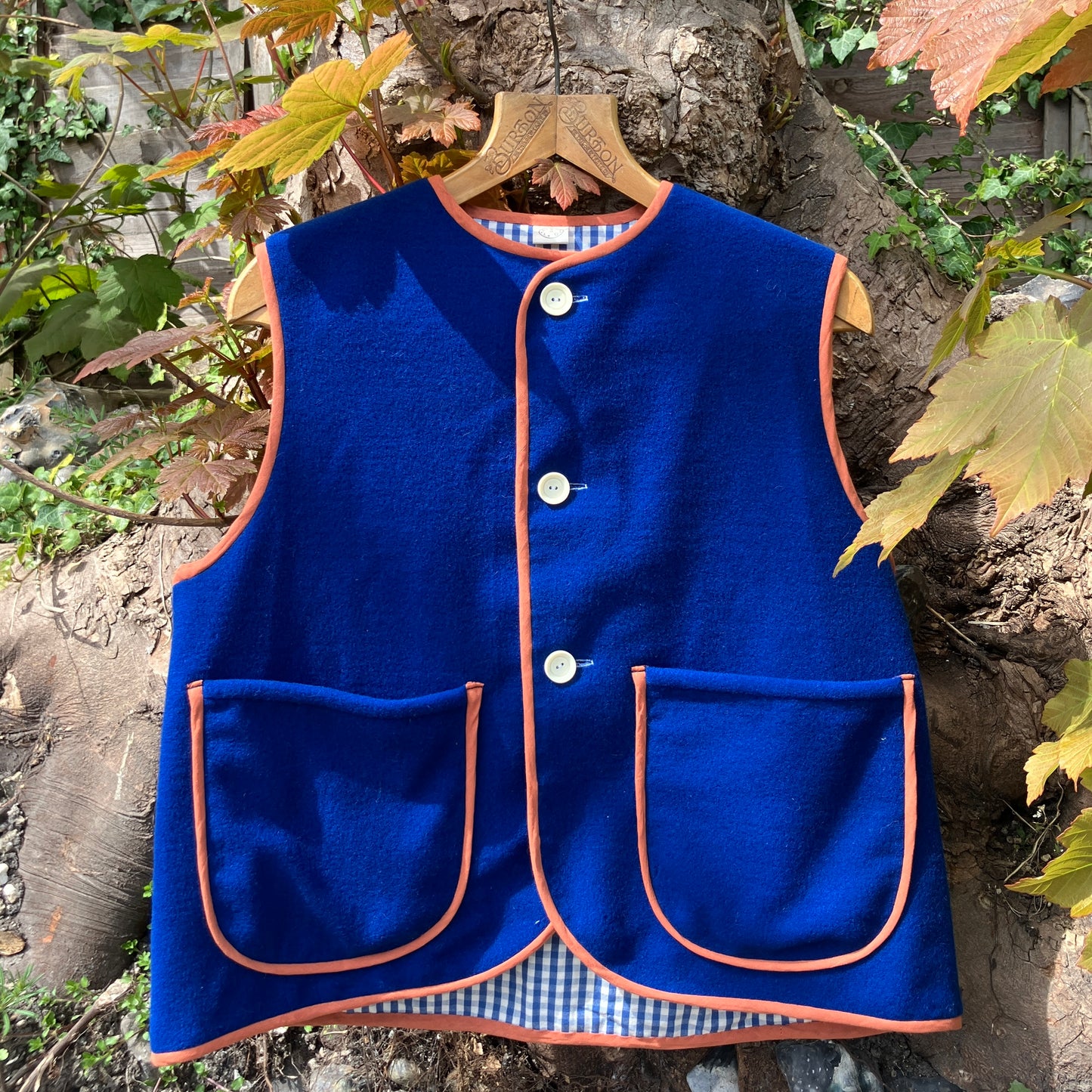 Vest made from a piece of soft cobalt blue wool, lined with cotton gingham