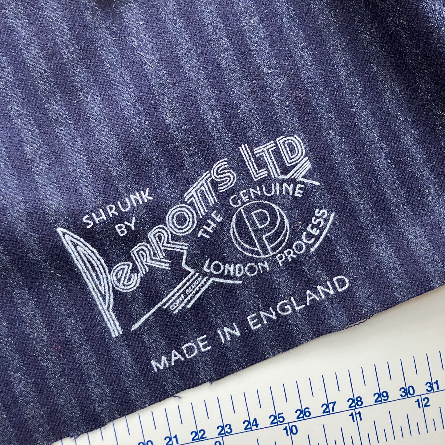 Beautiful quality vintage deadstock blue striped wool vest with found wooden buttons - detail of maker's mark