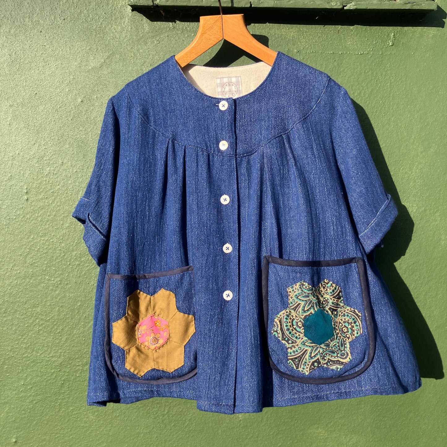Smock top hand made from deadstock denim with thrifted patchwork hexagons on the pockets