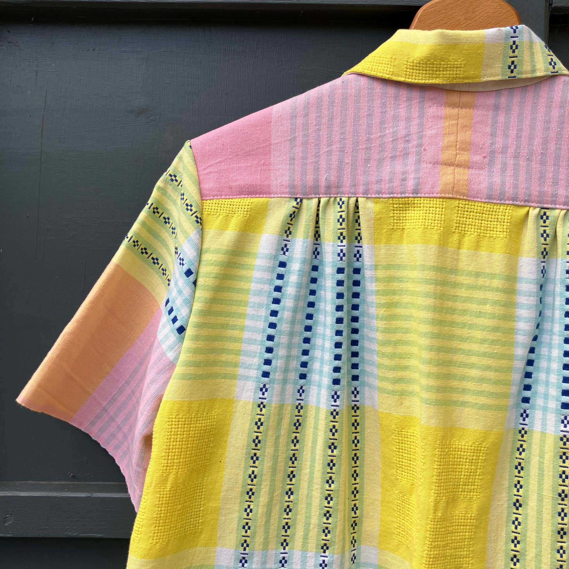 Shirt made from a reclaimed cotton tablecloth in shades of pink, blue, peach and bright yellow