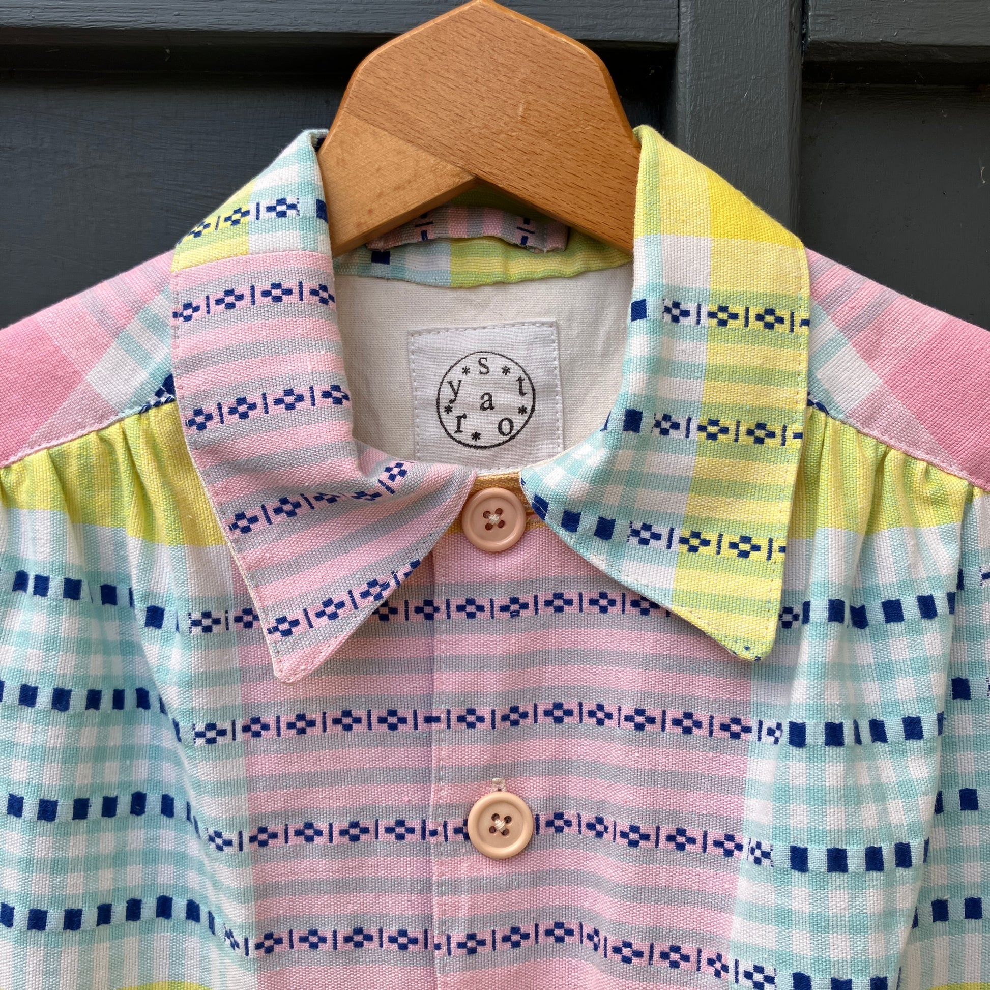 Shirt made from a reclaimed cotton tablecloth in shades of pink, blue, peach and bright yellow