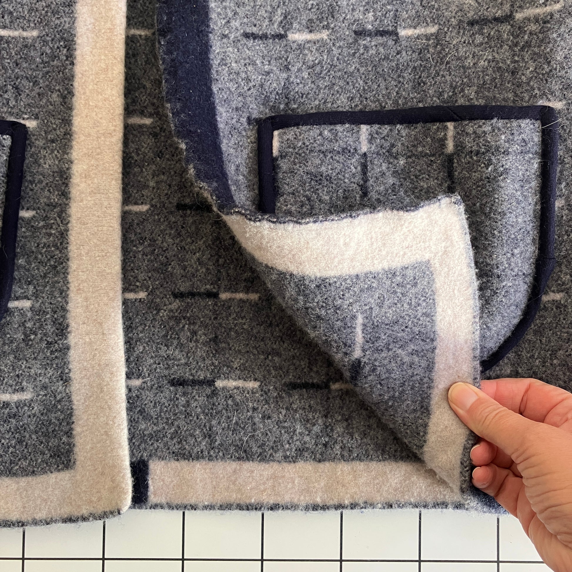 Cosy vest made from a reclaimed grey and blue lambswool blanket with two tie fastenings