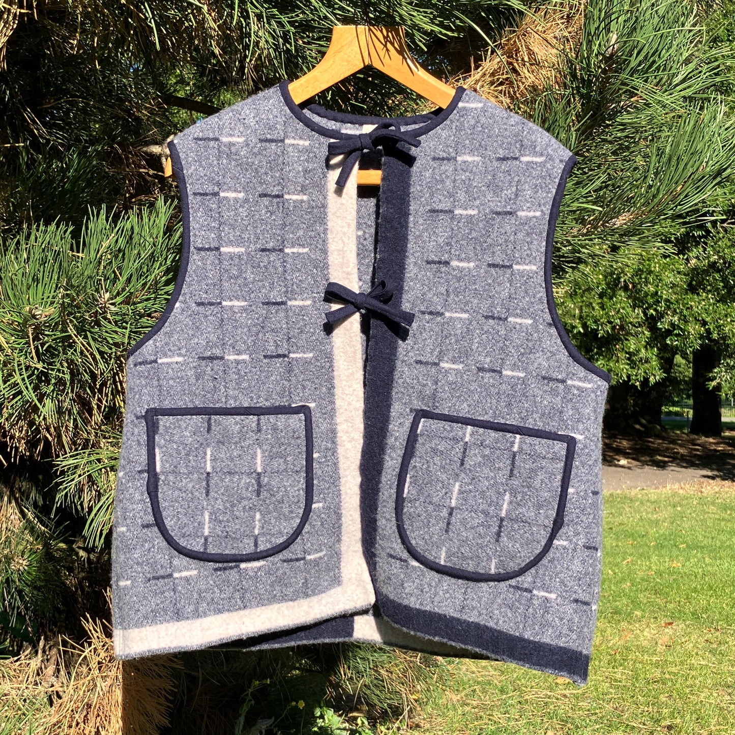 Cosy vest made from a reclaimed grey and blue lambswool blanket with two tie fastenings