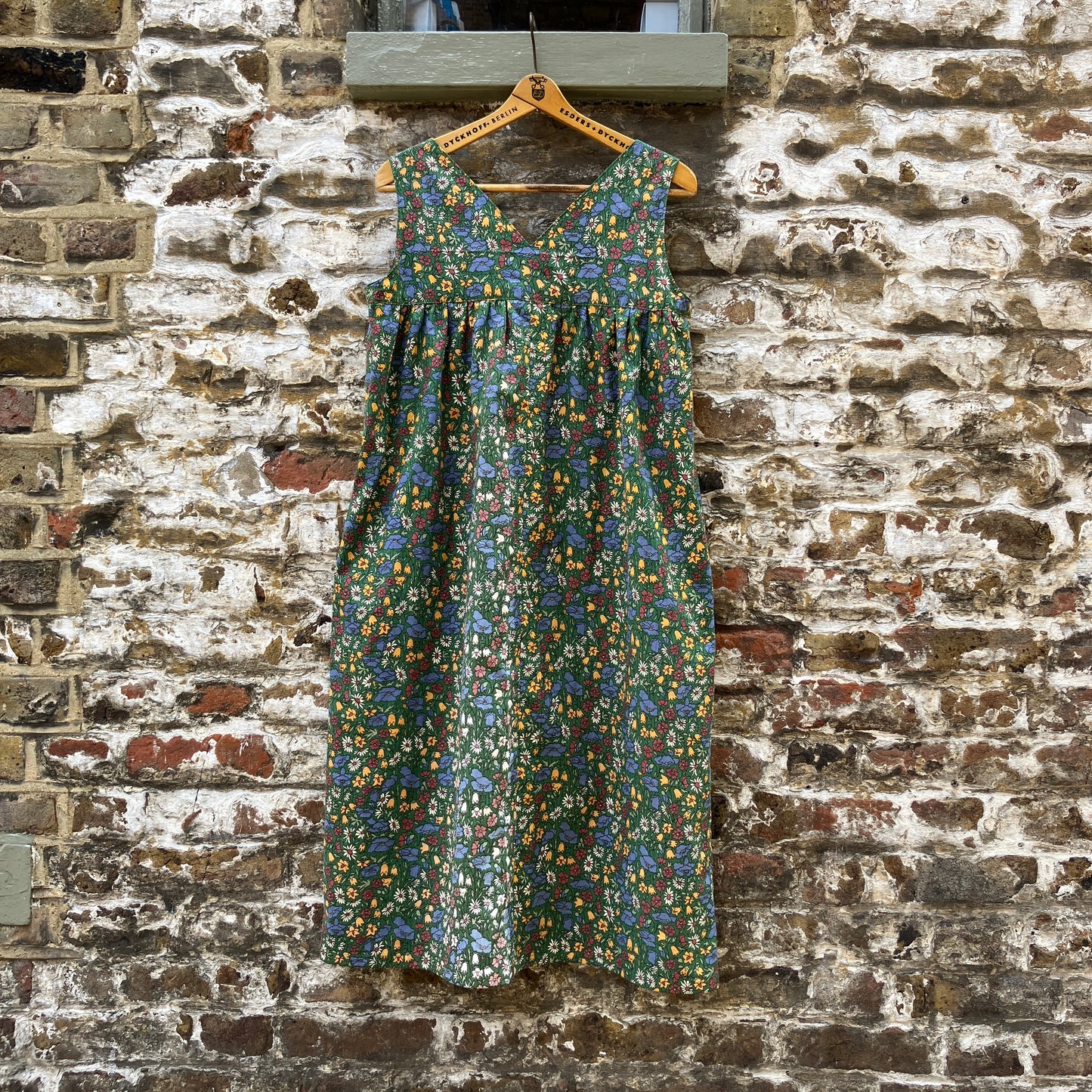 Button-shoulder, below-knee dress made from a reclaimed vintage 60s/70s Liberty Print curtain in a pretty floral print. (back view)