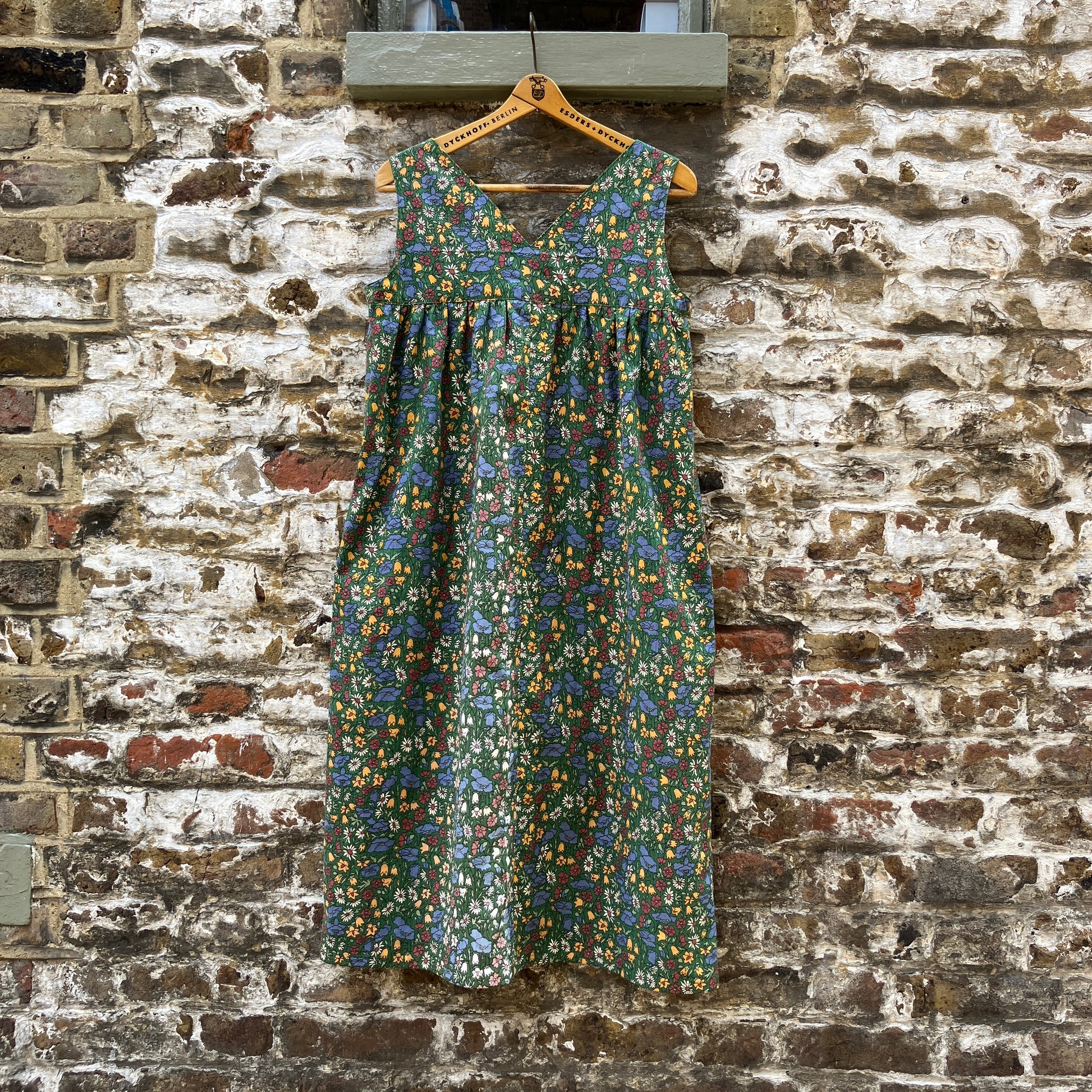 Button-shoulder, below-knee dress made from a reclaimed vintage 60s/70s Liberty Print curtain in a pretty floral print. (back view)