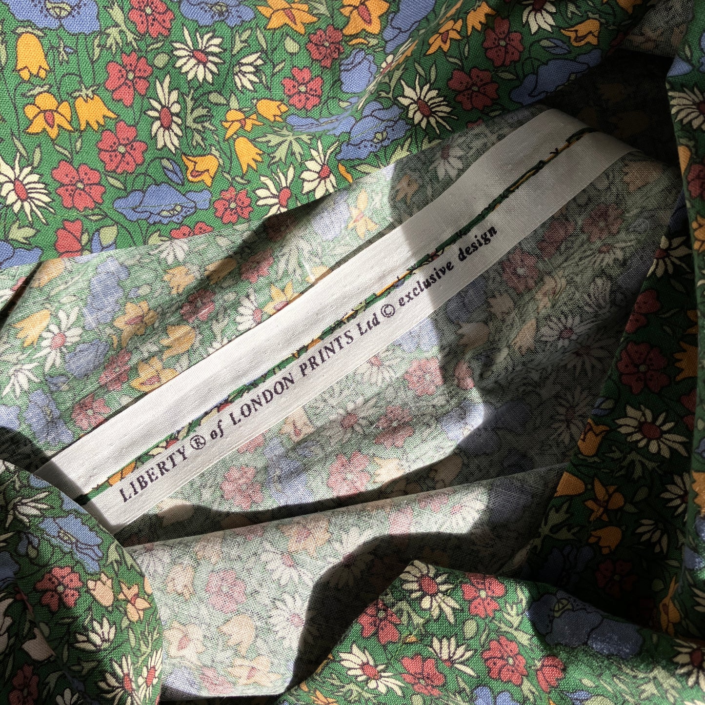 Button-shoulder, below-knee dress made from a reclaimed vintage 60s/70s Liberty Print curtain in a pretty floral print.