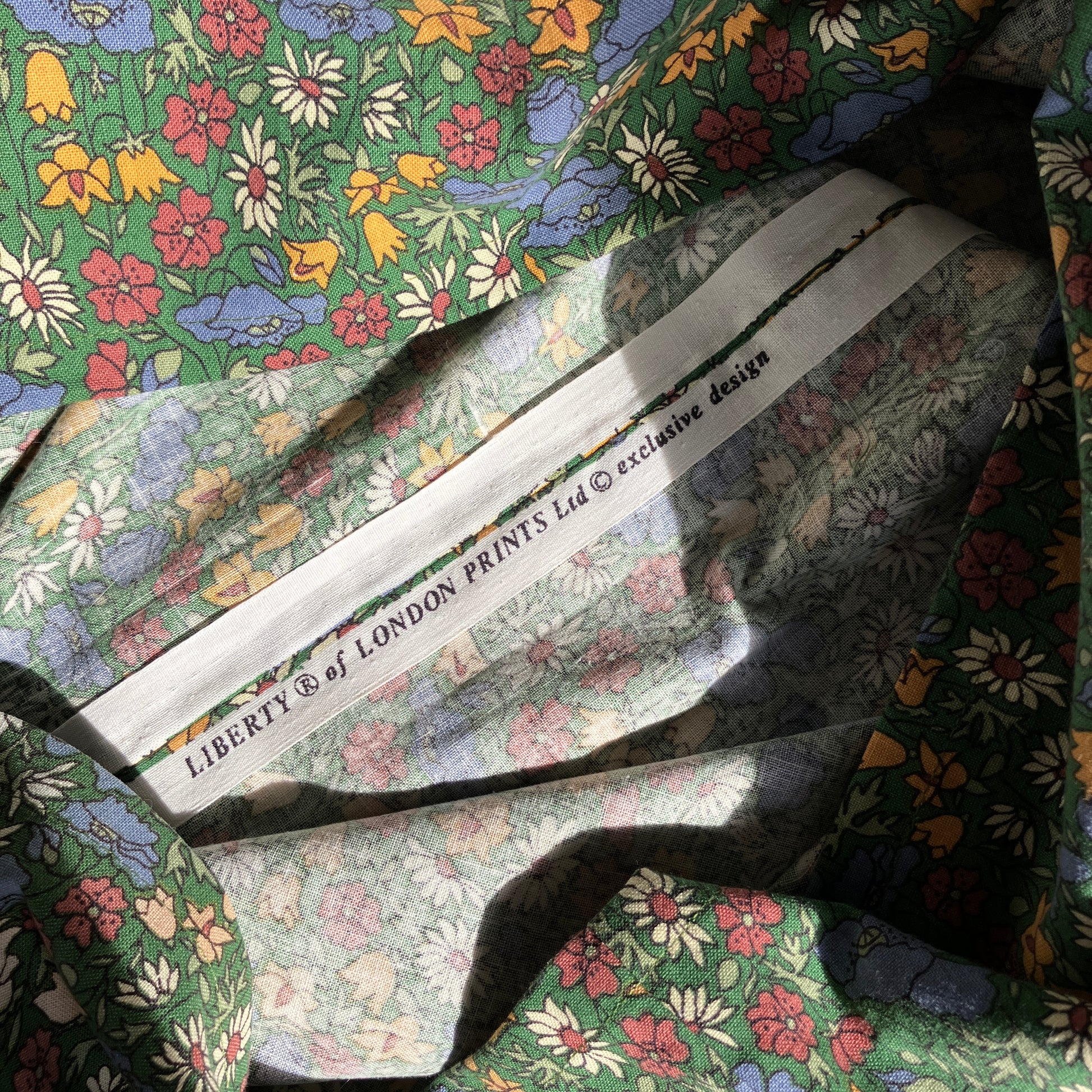 Button-shoulder, below-knee dress made from a reclaimed vintage 60s/70s Liberty Print curtain in a pretty floral print.