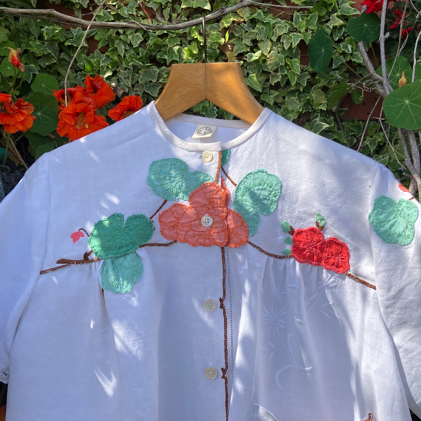 summer top hand made from a reclaimed tablecloth with appliqué nasturtiums in red, orange, peach and green