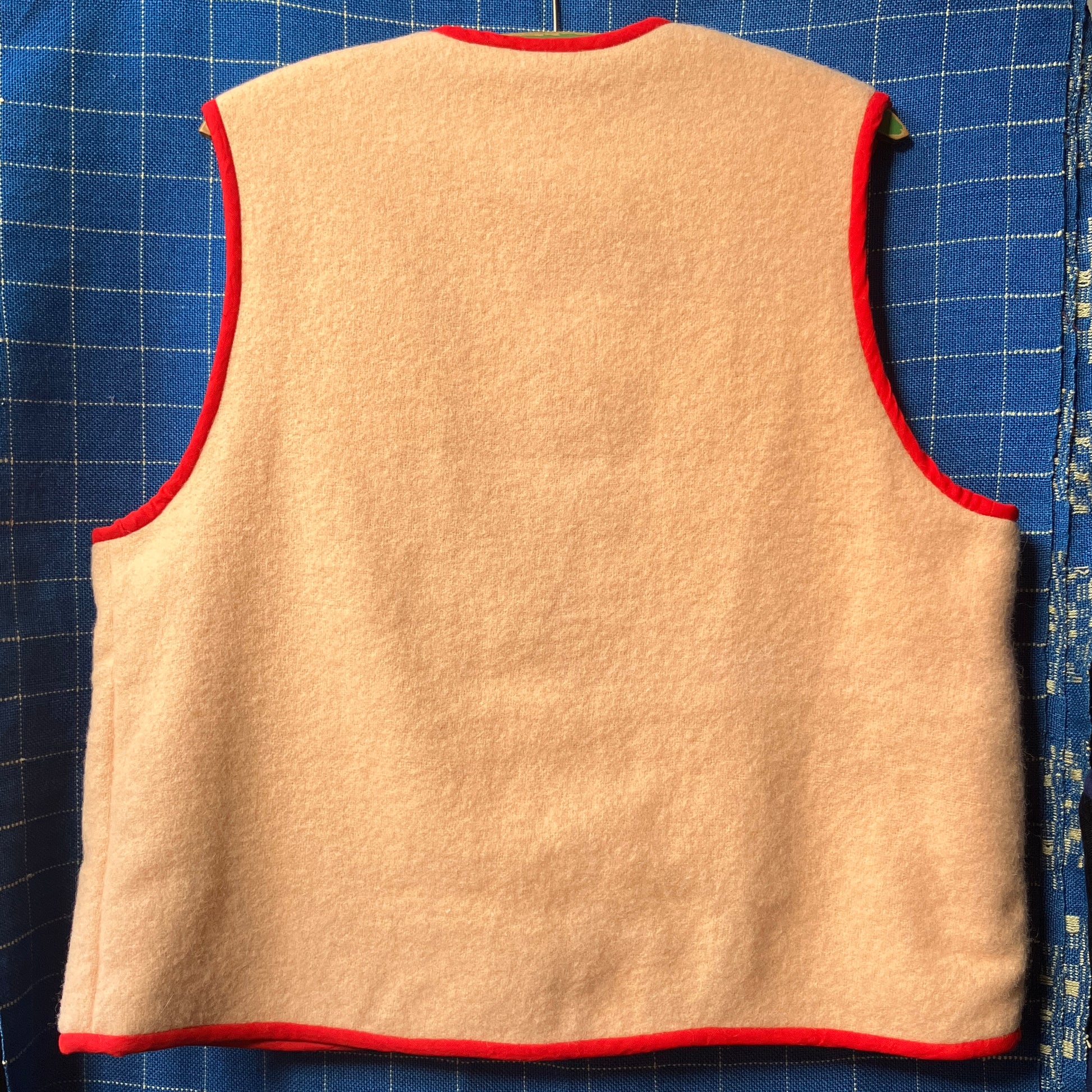 Vest/waistcoat made from a recycled vintage pink wool blanket, with red cotton binding and vintage wooden toggles
