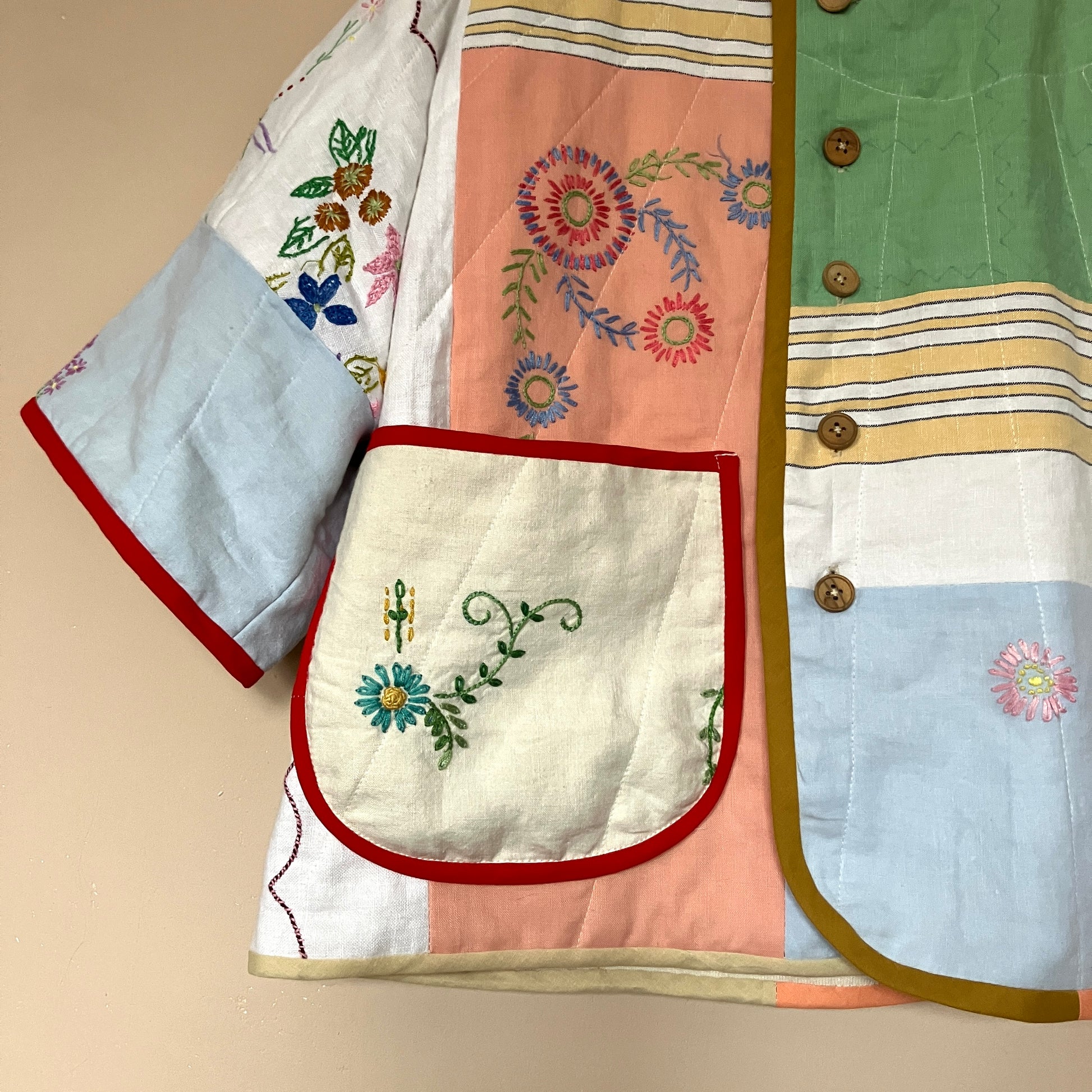 quilted top or jacket made from a patchwork of vintage tablecloths