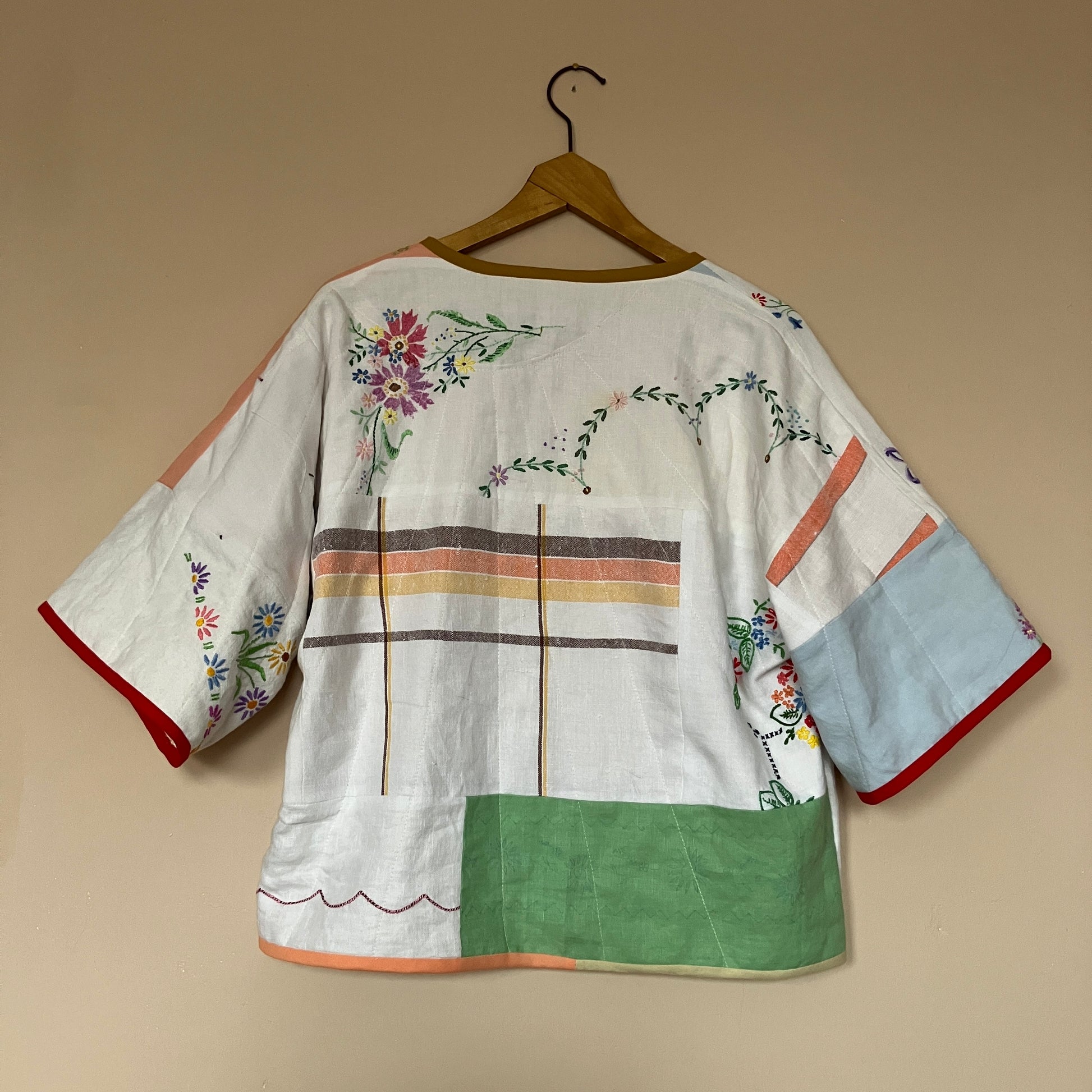 quilted top or jacket made from a patchwork of vintage tablecloths