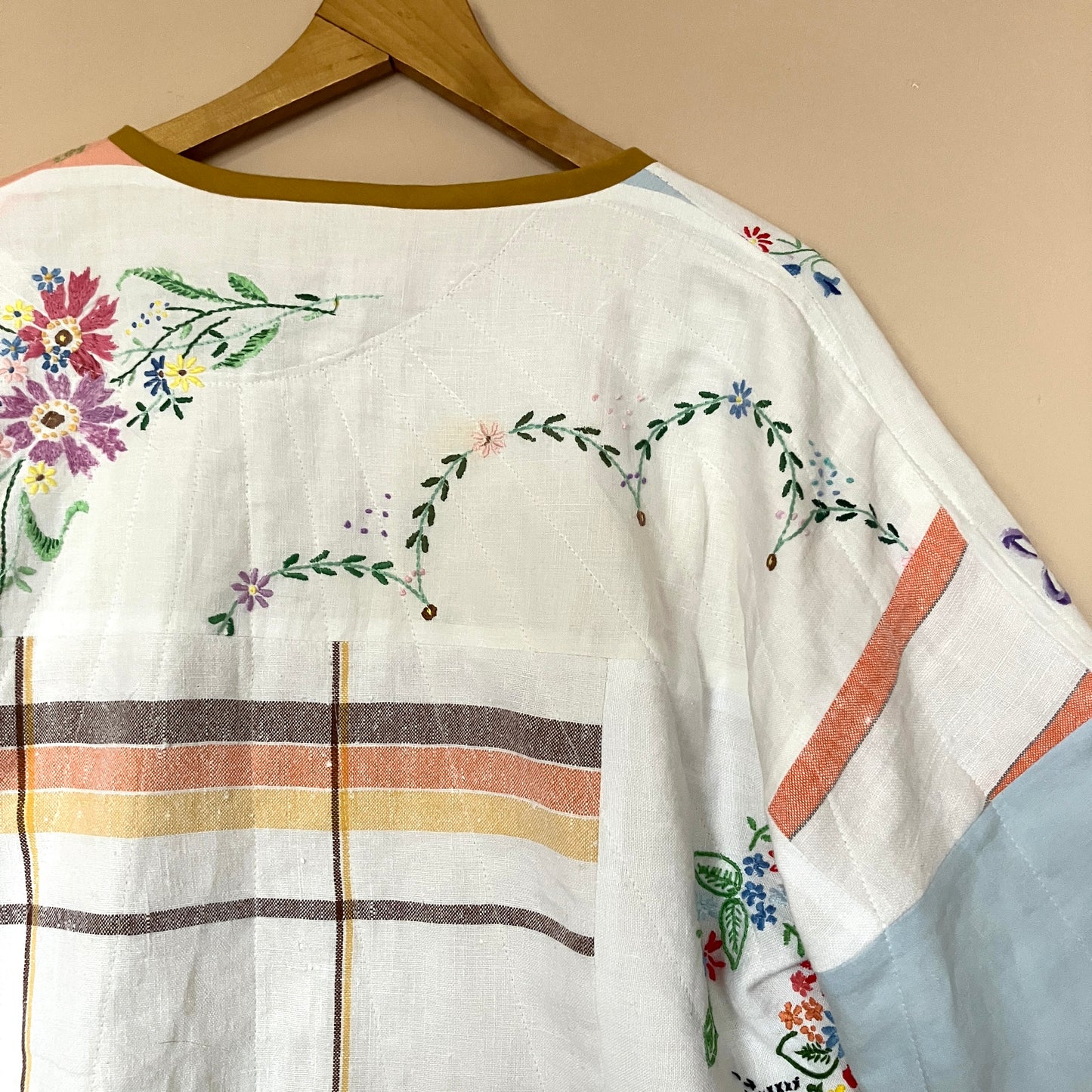 quilted top or jacket made from a patchwork of vintage tablecloths