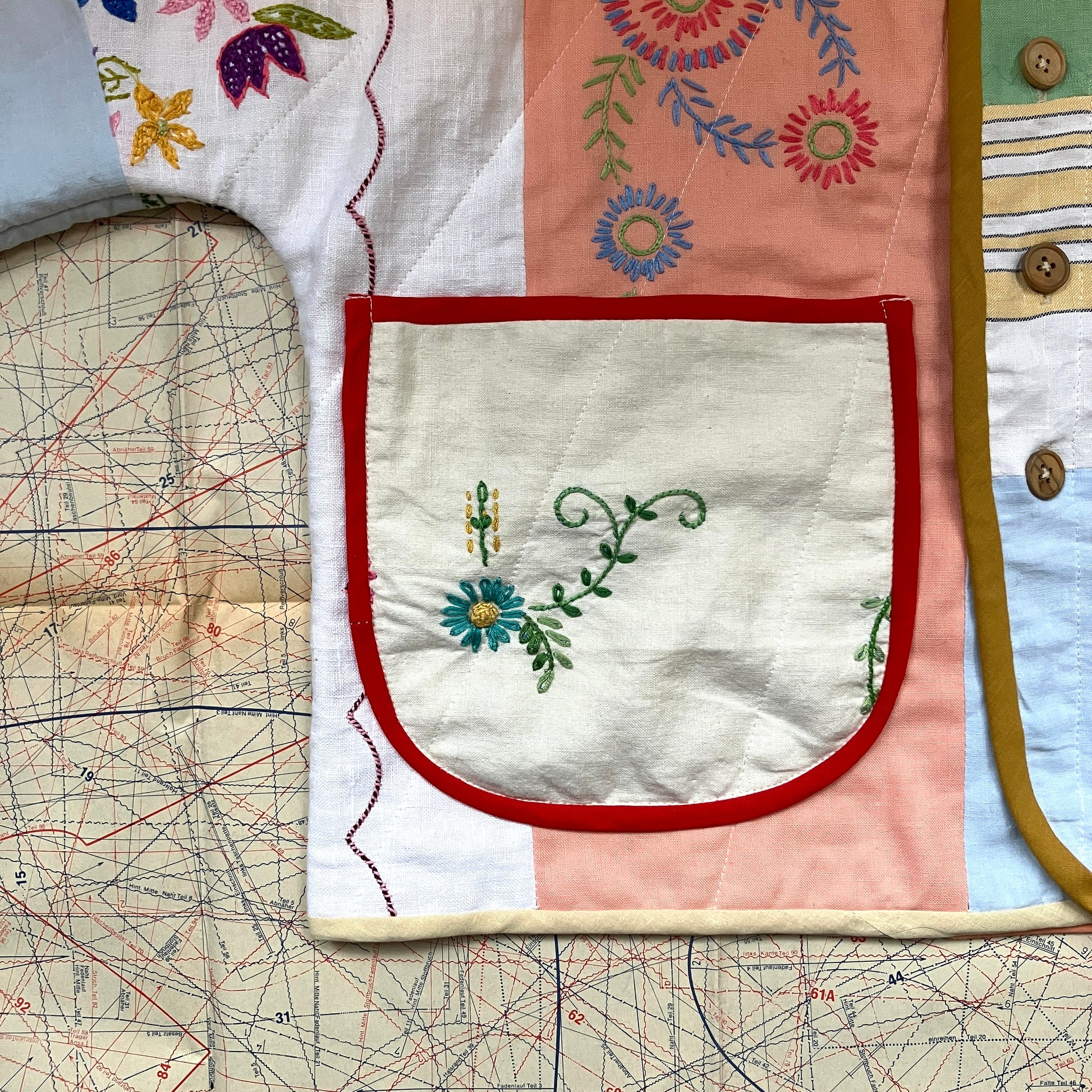 quilted top or jacket made from a patchwork of vintage tablecloths