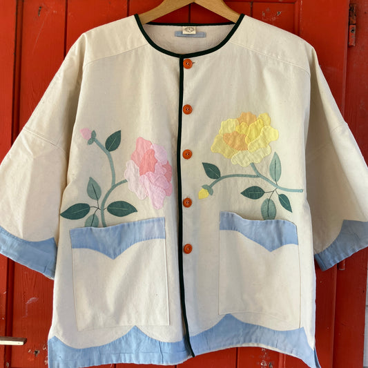 Pretty boxy top with pastel-coloured floral appliqué, made from a vintage cotton bedspread with scalloped edges