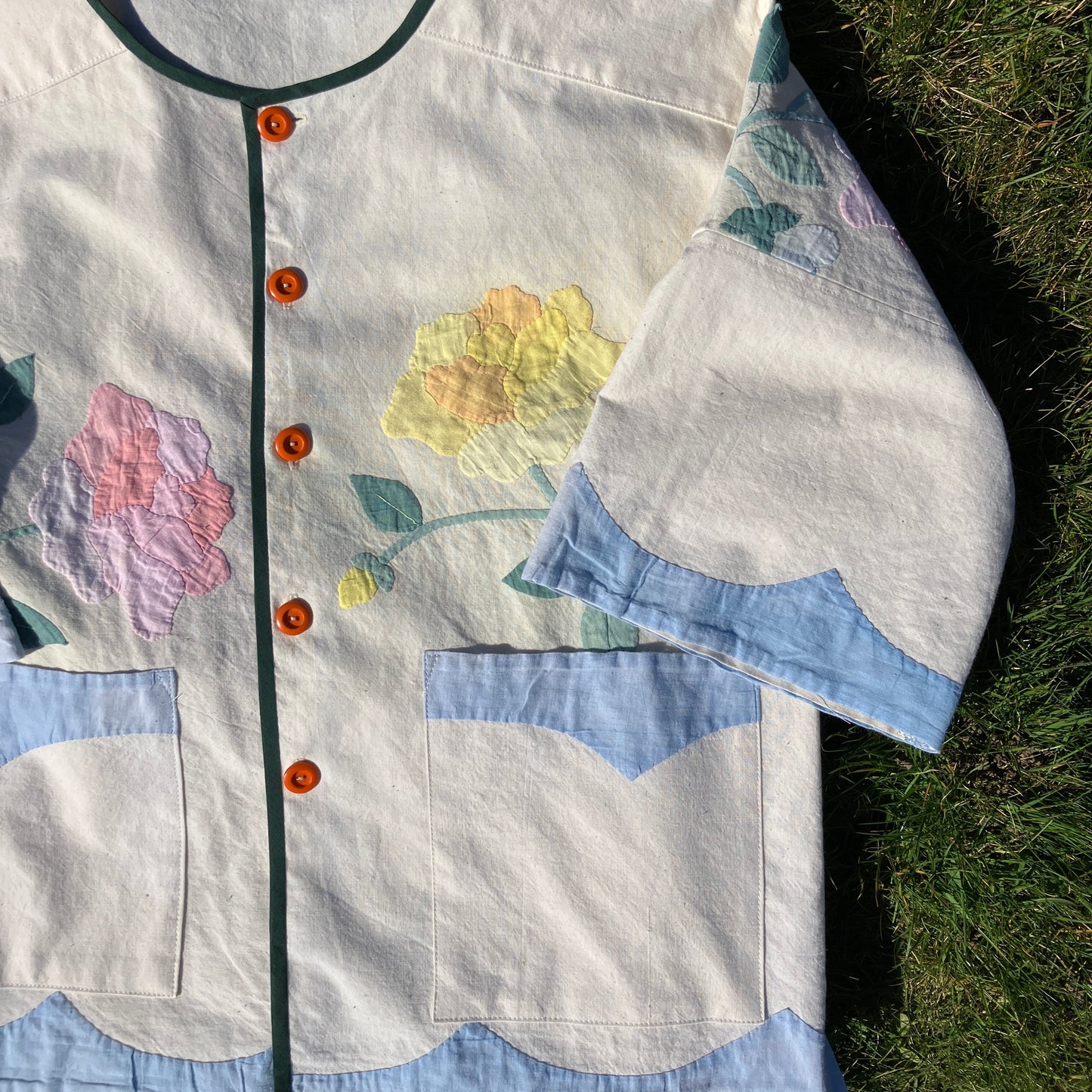 Pretty boxy top with pastel-coloured floral appliqué, made from a vintage cotton bedspread with scalloped edges