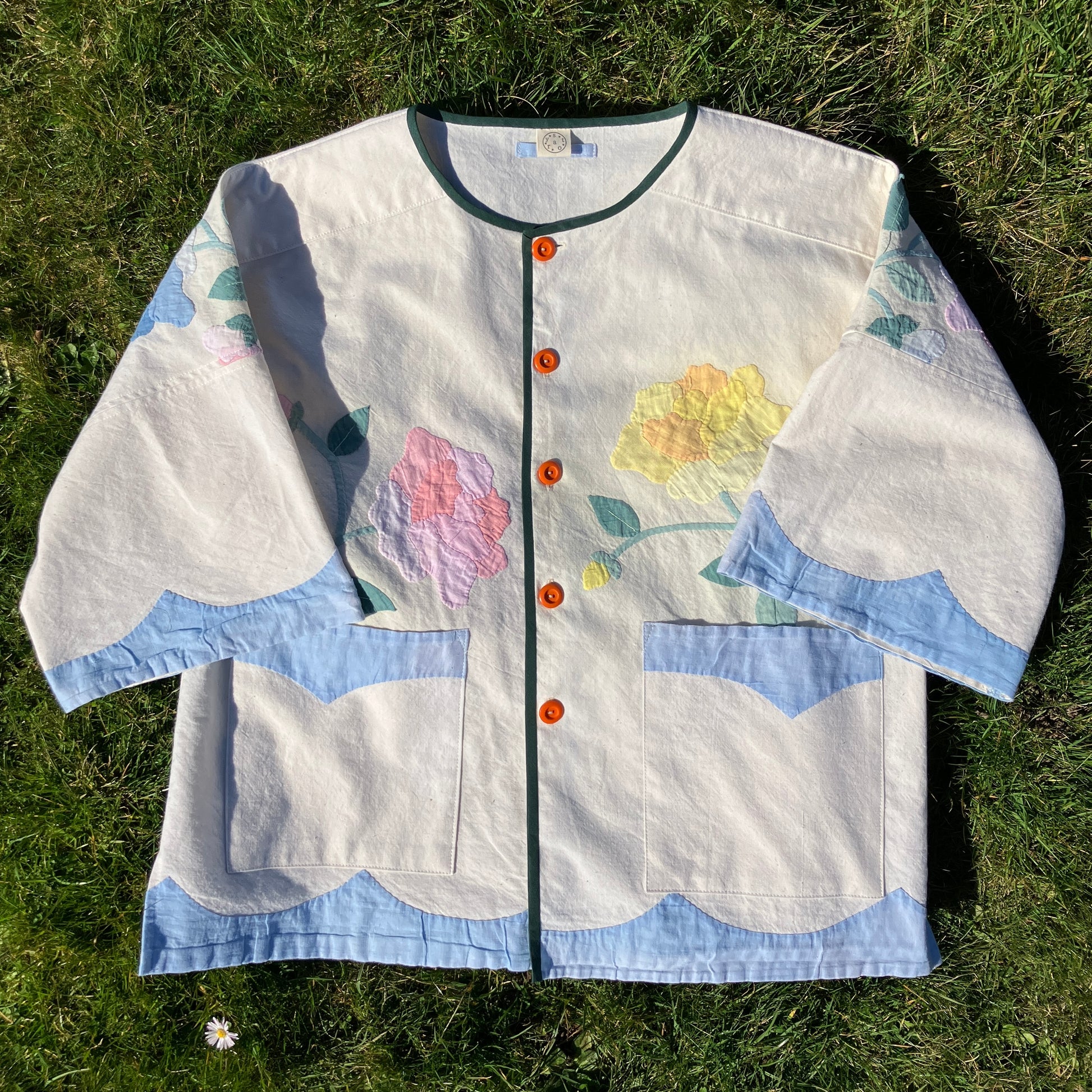 Pretty boxy top with pastel-coloured floral appliqué, made from a vintage cotton bedspread with scalloped edges