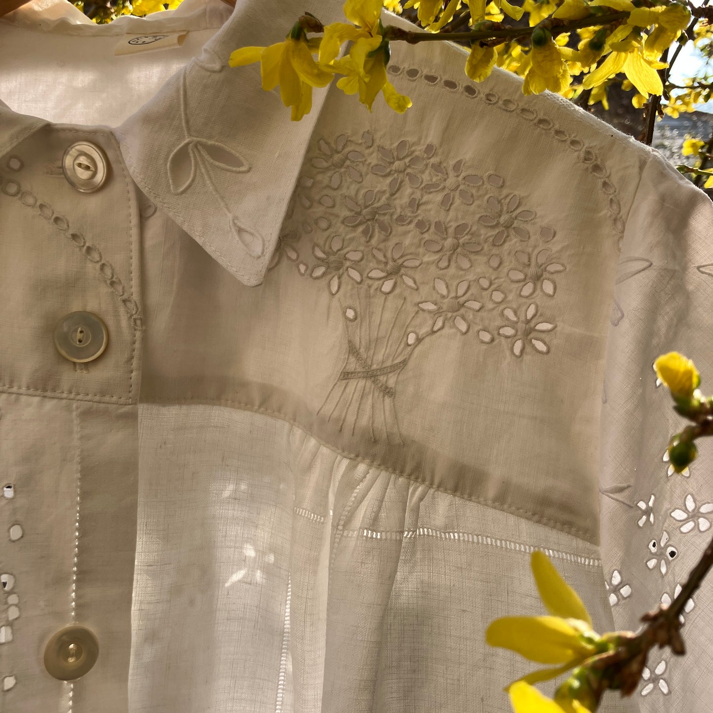pretty, breezy blouse made from a
patchwork of reclaimed vintage cotton and linen white cutwork tablecloths.