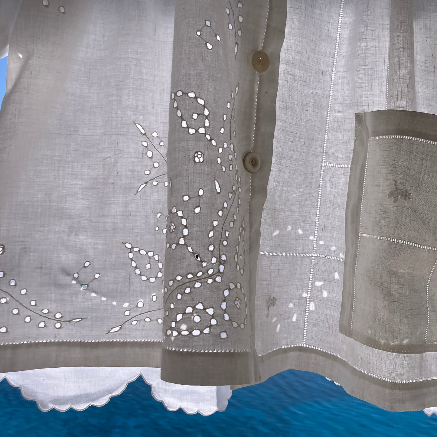 pretty, breezy blouse made from a
patchwork of reclaimed vintage cotton and linen white cutwork tablecloths.