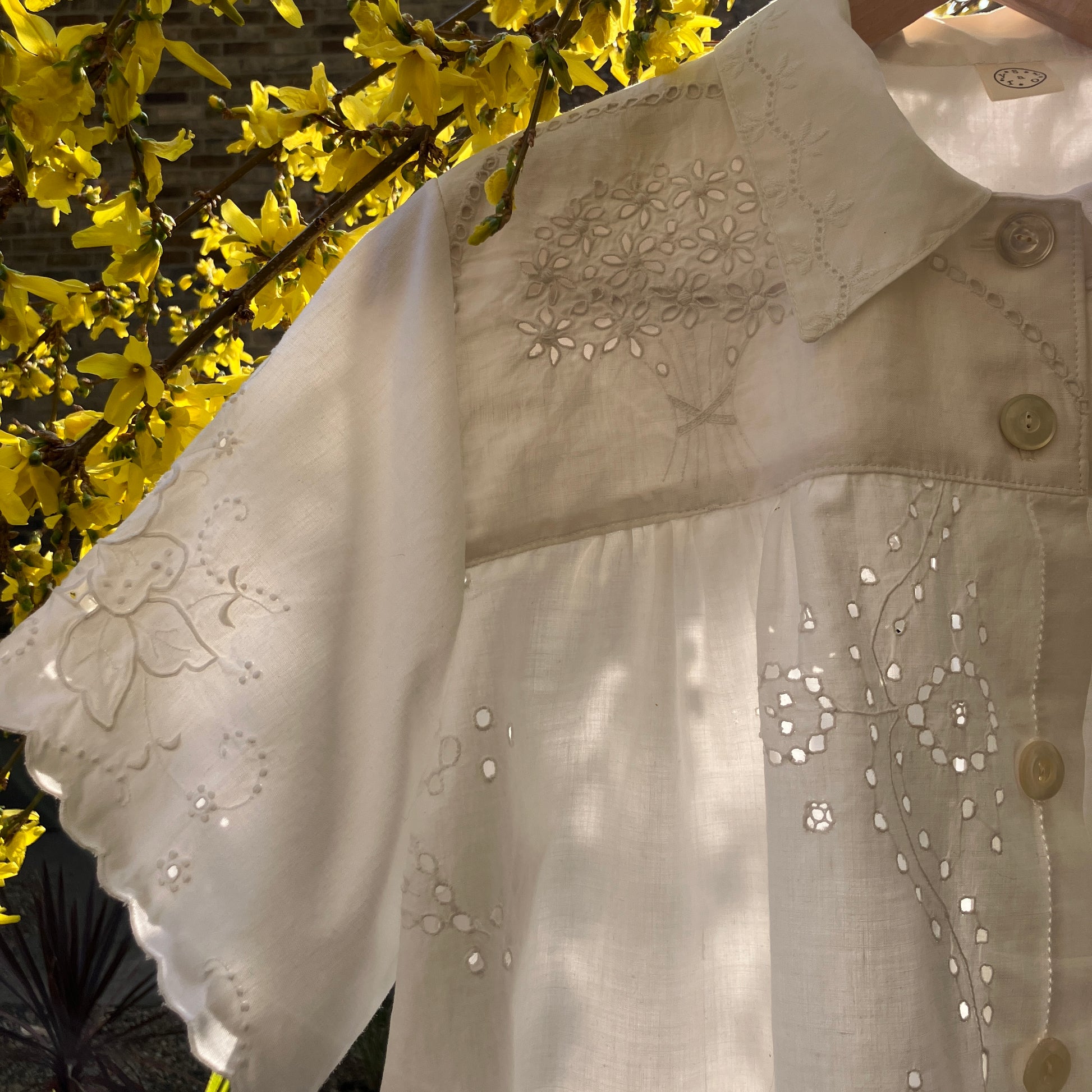 pretty, breezy blouse made from a 
patchwork of reclaimed vintage cotton and linen white cutwork tablecloths.
