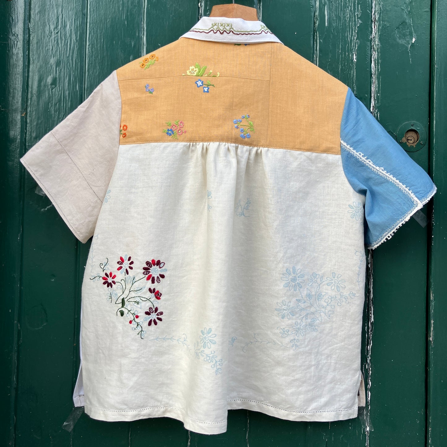 Recycled fabric shirt with embroidery depicting a village pub