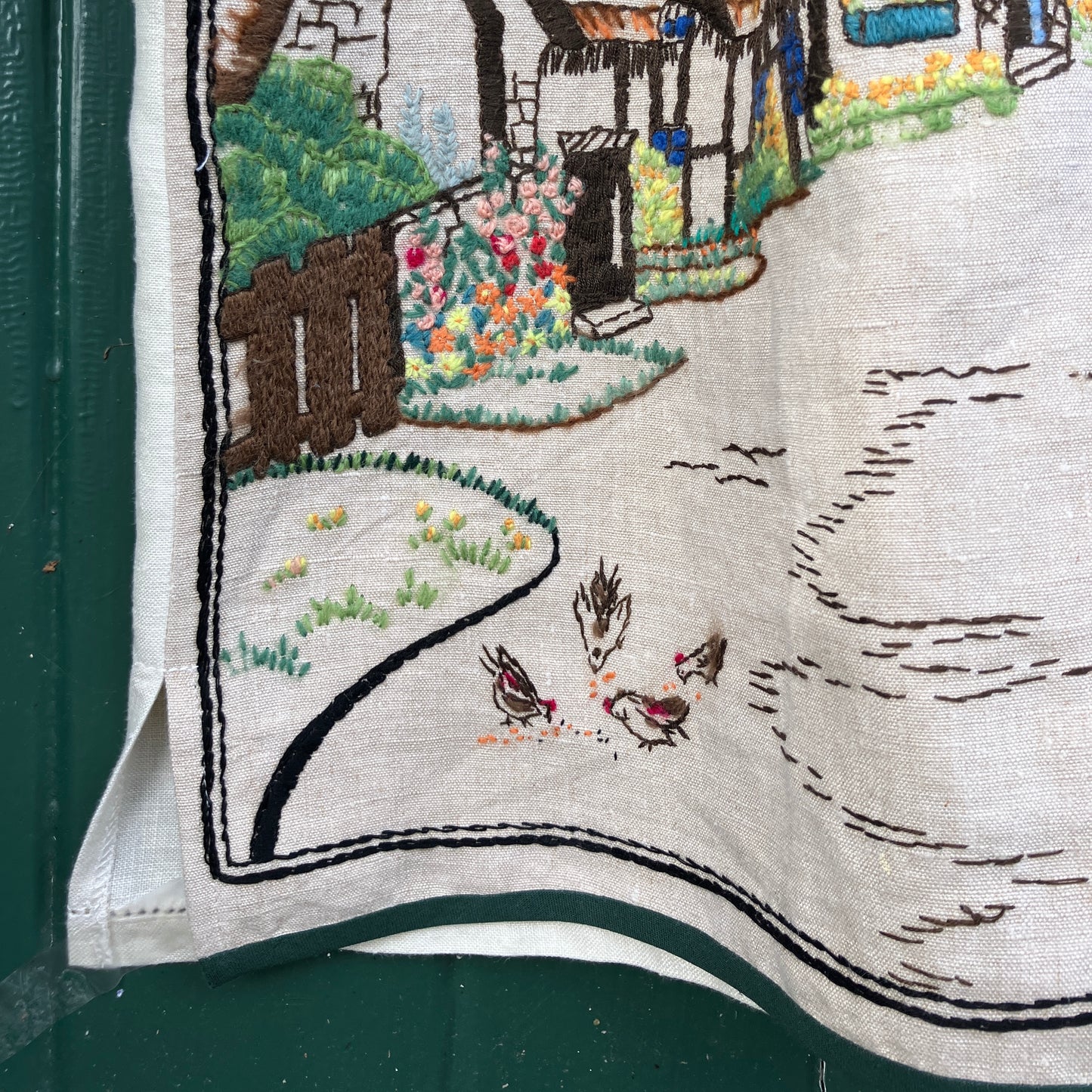 Recycled fabric shirt with embroidery depicting a village pub