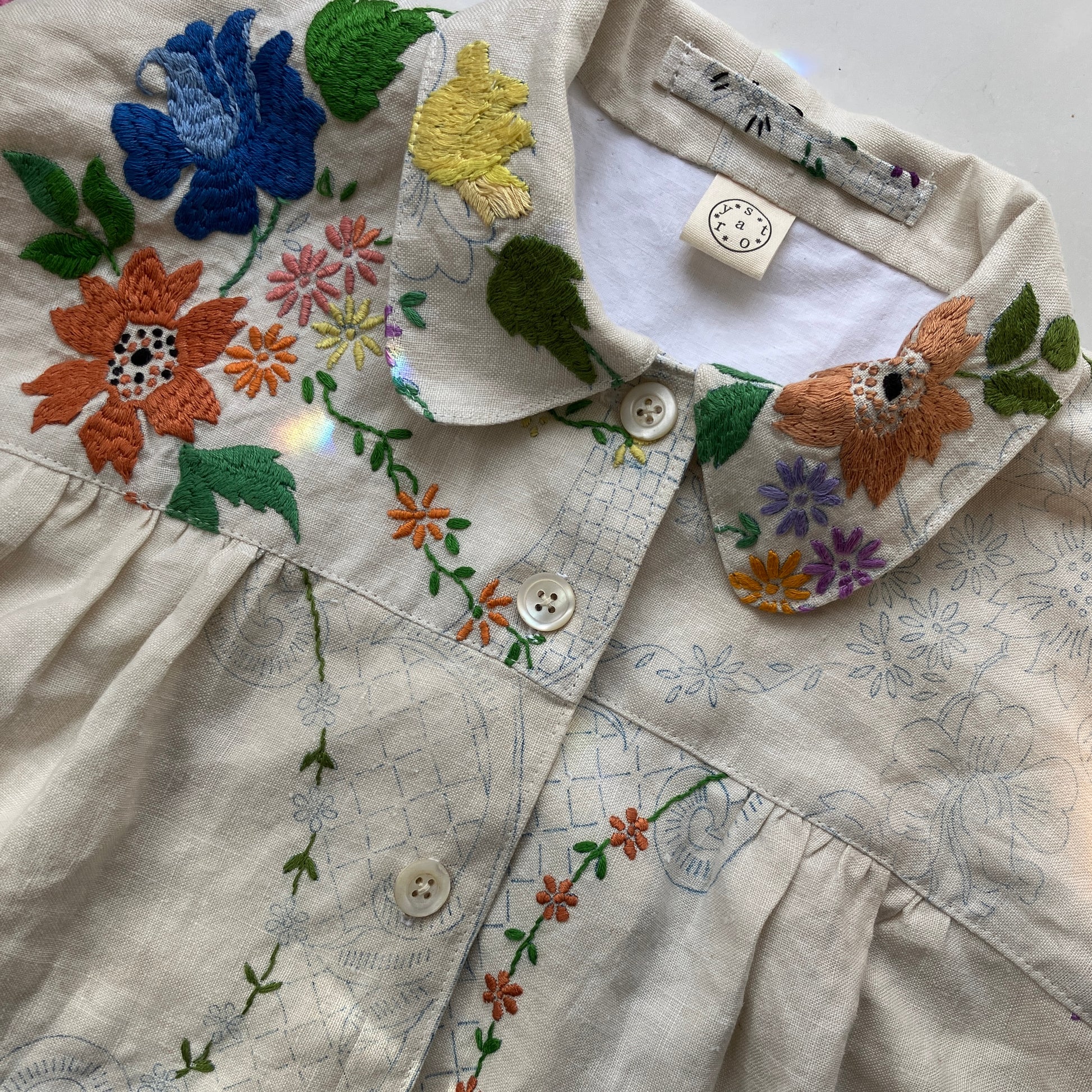 Blouse made from a recycled part-embroidered vintage linen tablecloth