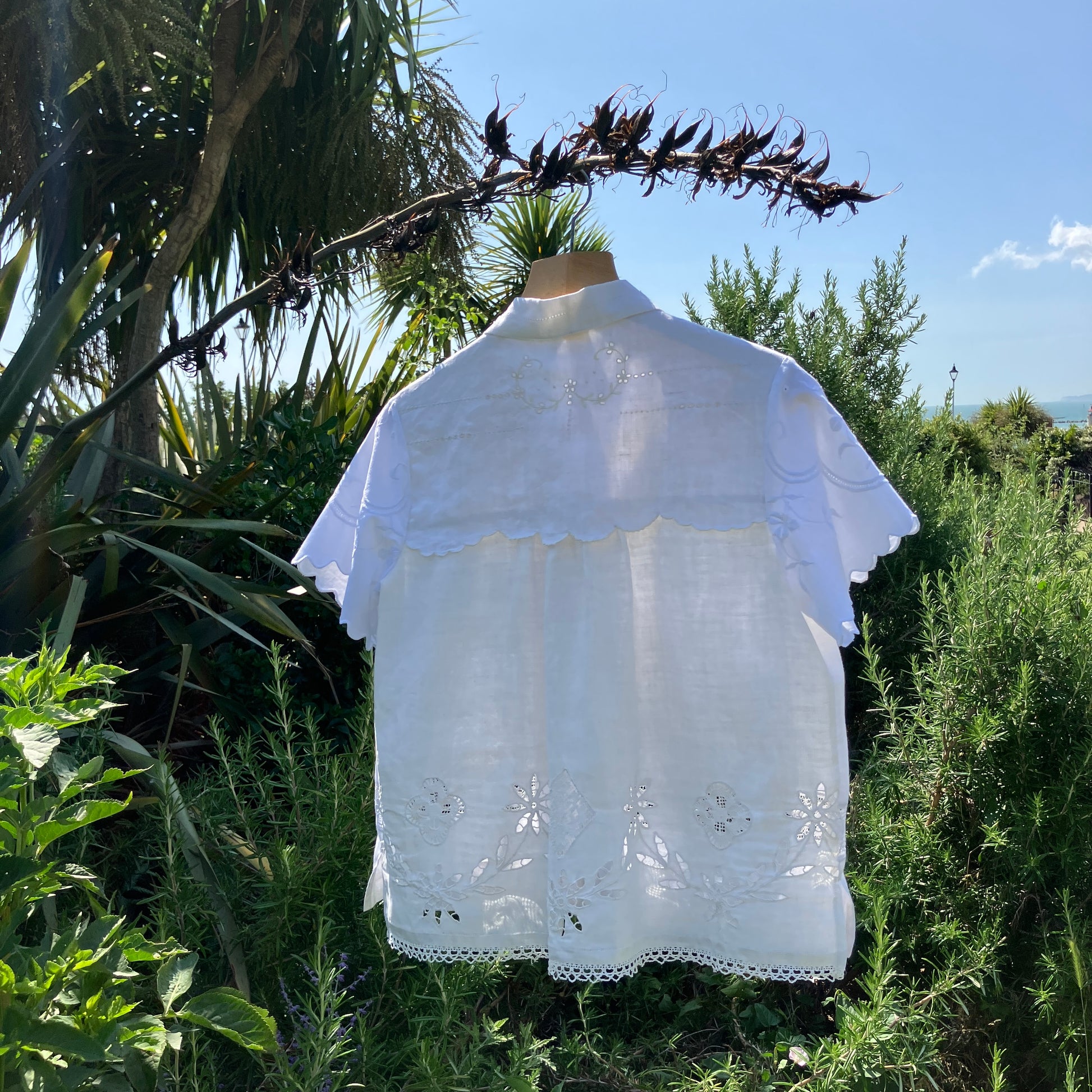 Short-sleeved white swingy shirt made from vintage cutwork linen and cotton cutwork table and tray cloths.