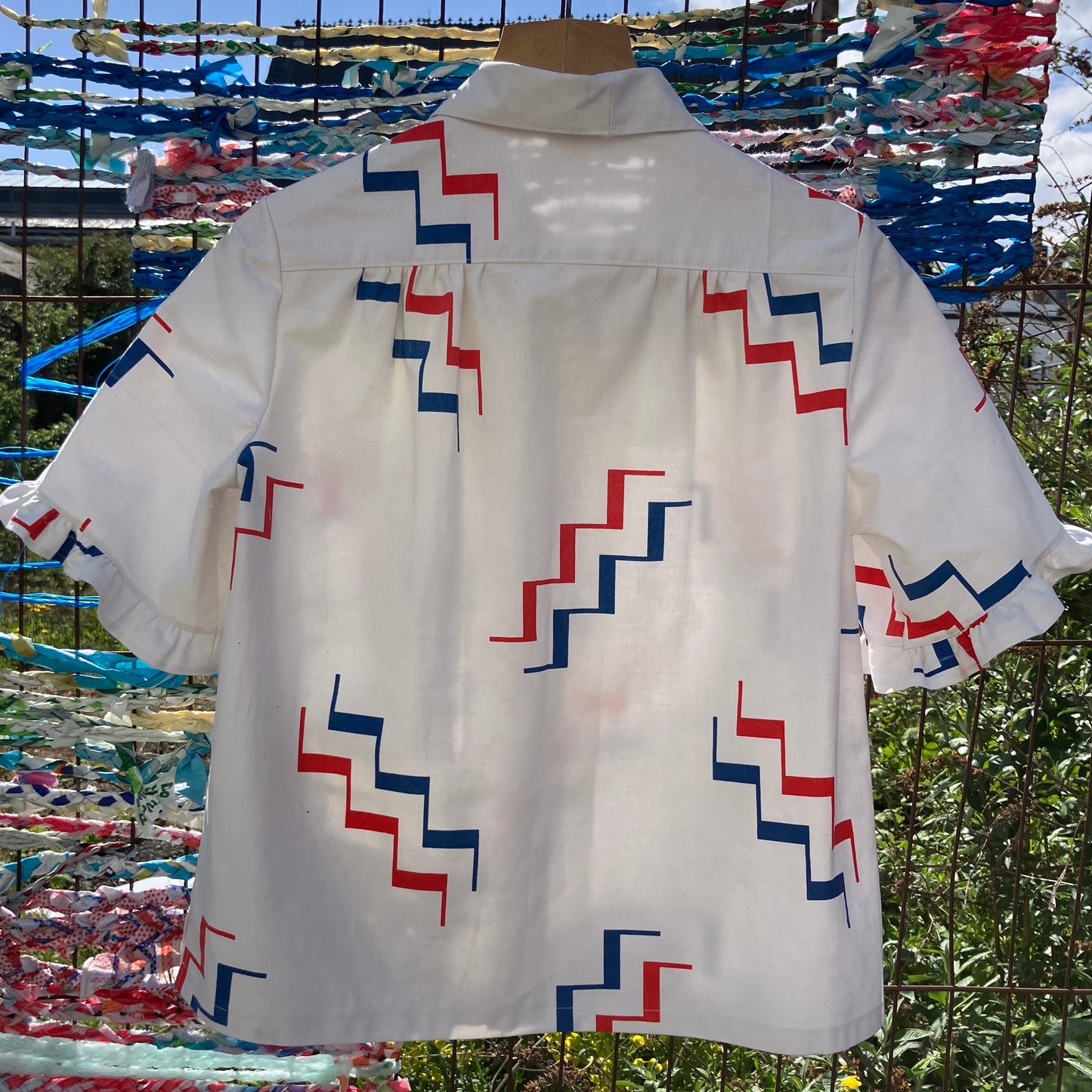 Geometric-print shirt with fancy ruffles around the sleeves