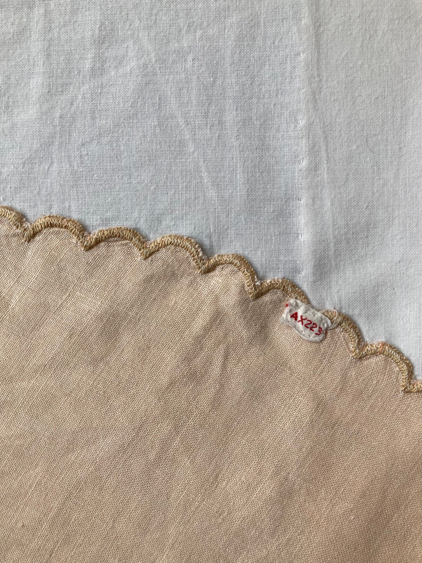 Handmade boxy shirt decorated with appliqué scallop-edge doilies, detail