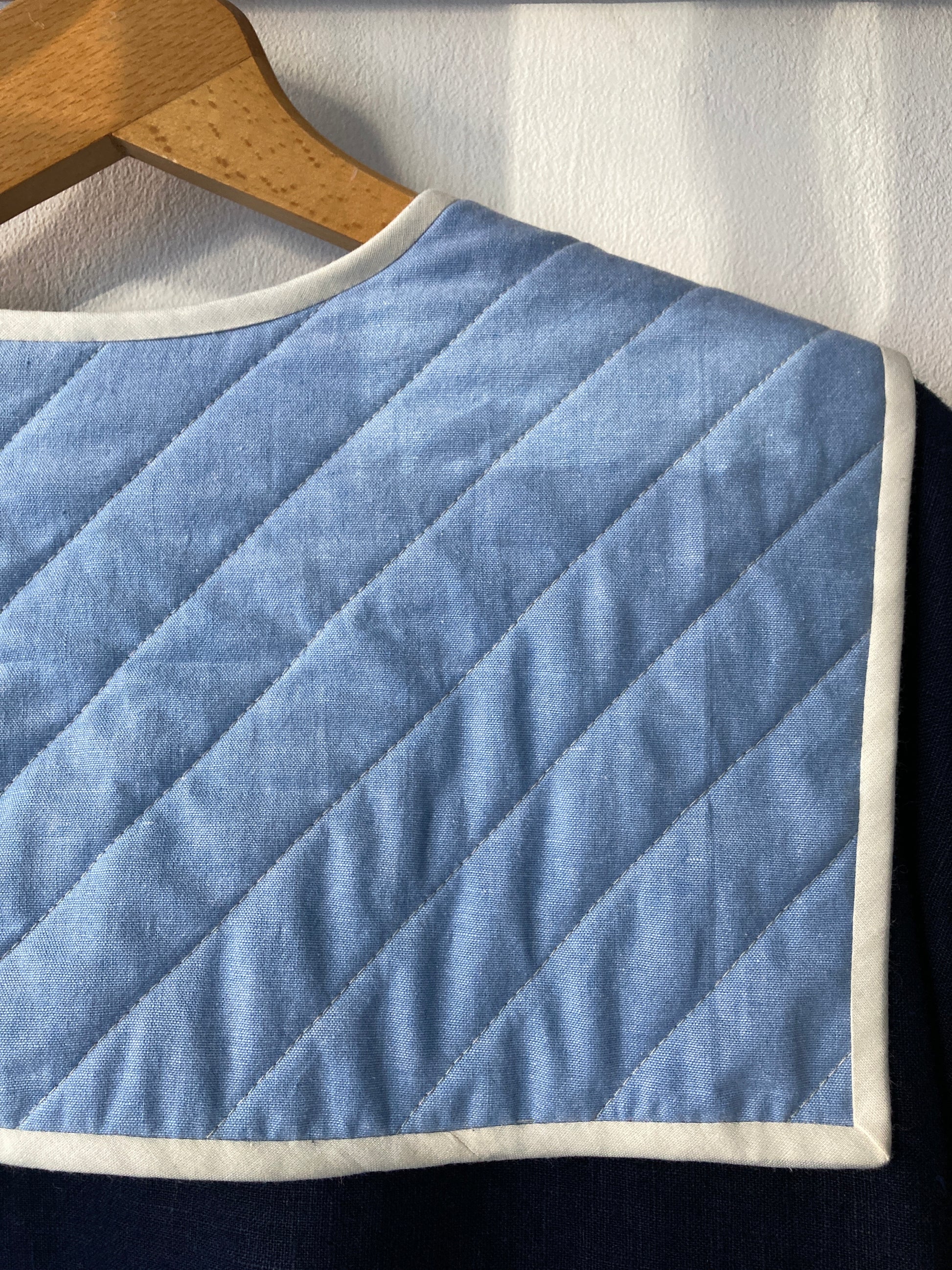 Hand sewn navy blue linen shirt made from reclaimed fabric with a quilted patchwork sailor collar (close-up of collar)