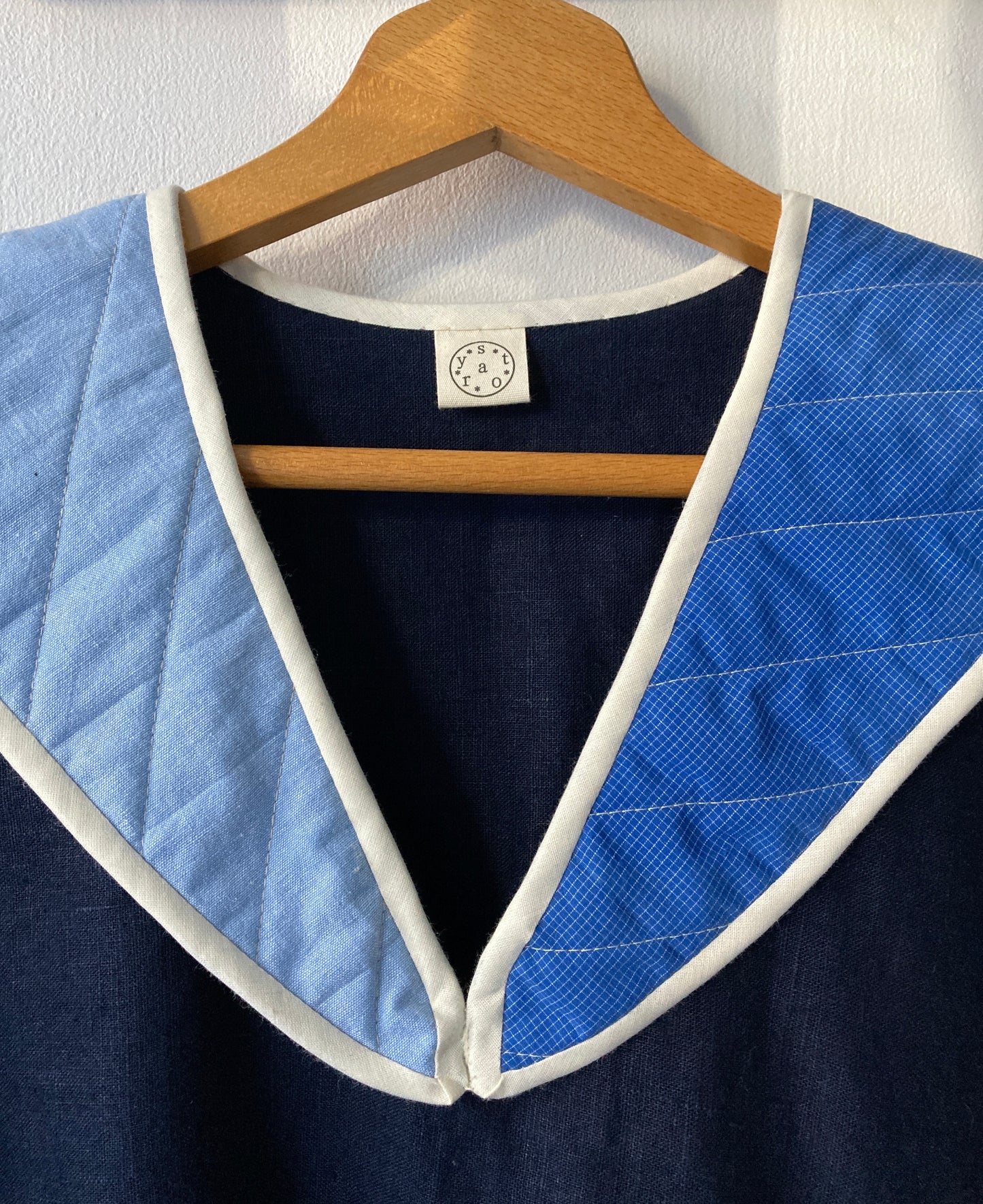 Hand sewn navy blue linen shirt made from reclaimed fabric with a quilted patchwork sailor collar (close-up of front)