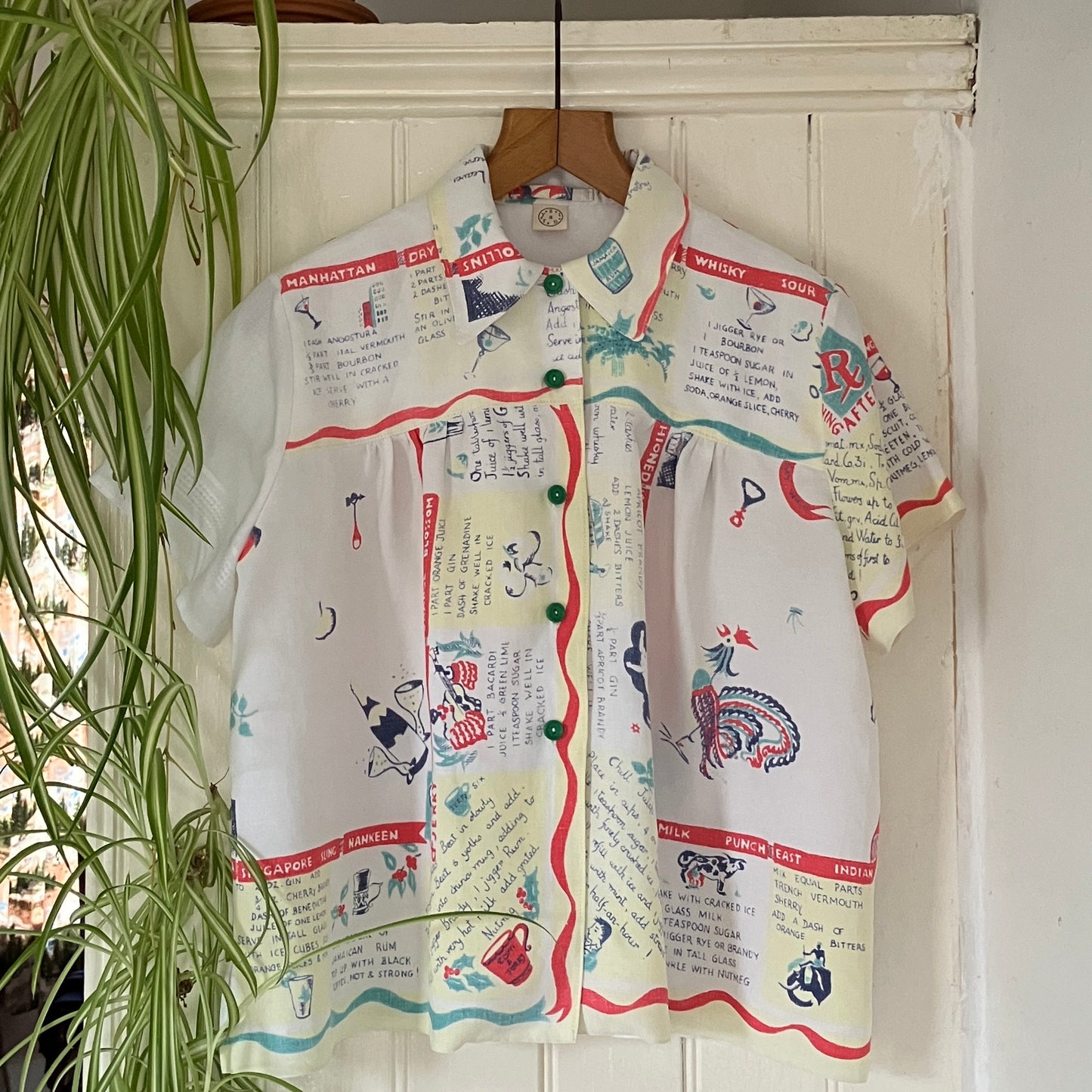 A shirt handmade from a vintage 'cocktails' tablecloth, featuring recipes and illustrations