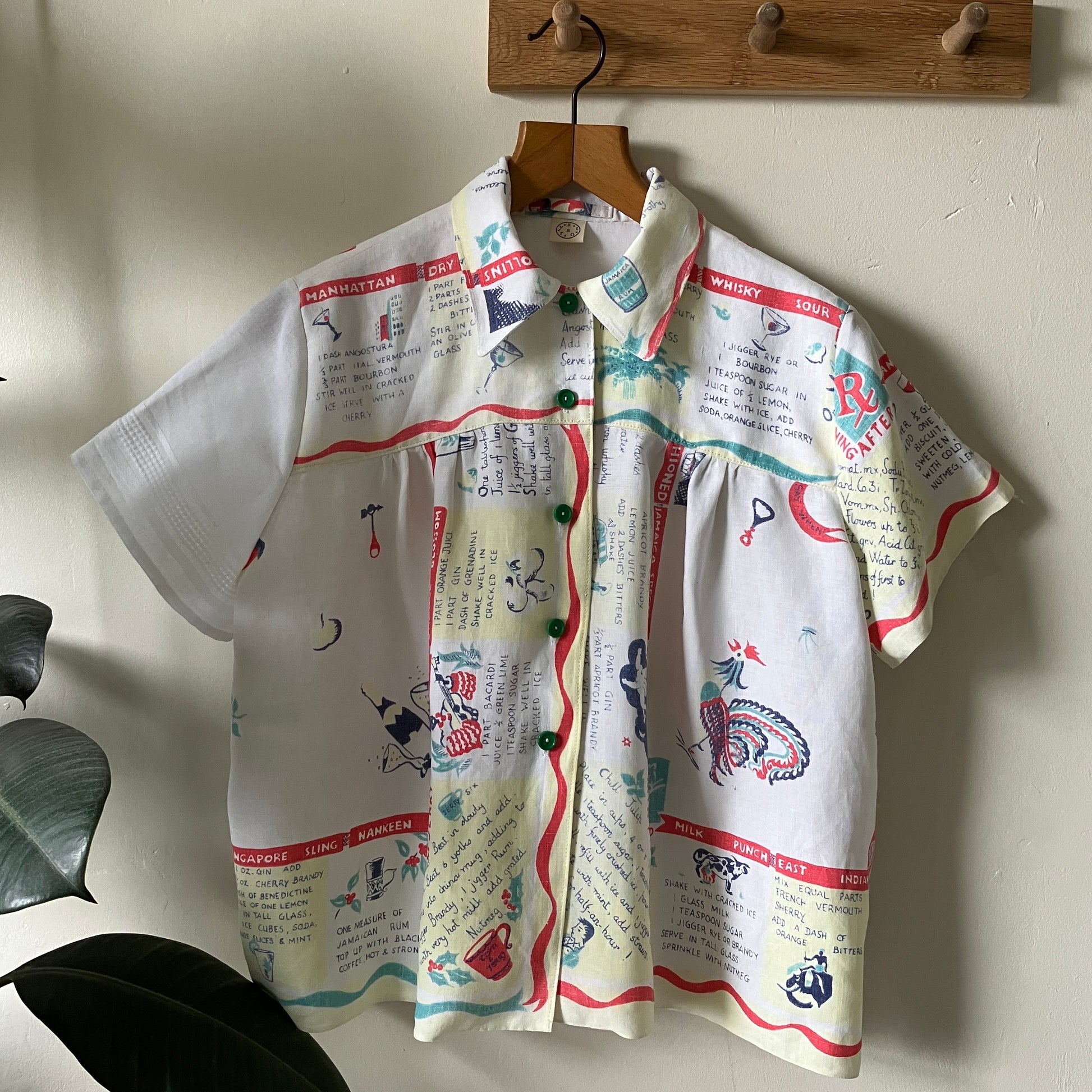 A shirt handmade from a vintage 'cocktails' tablecloth, featuring recipes and illustrations