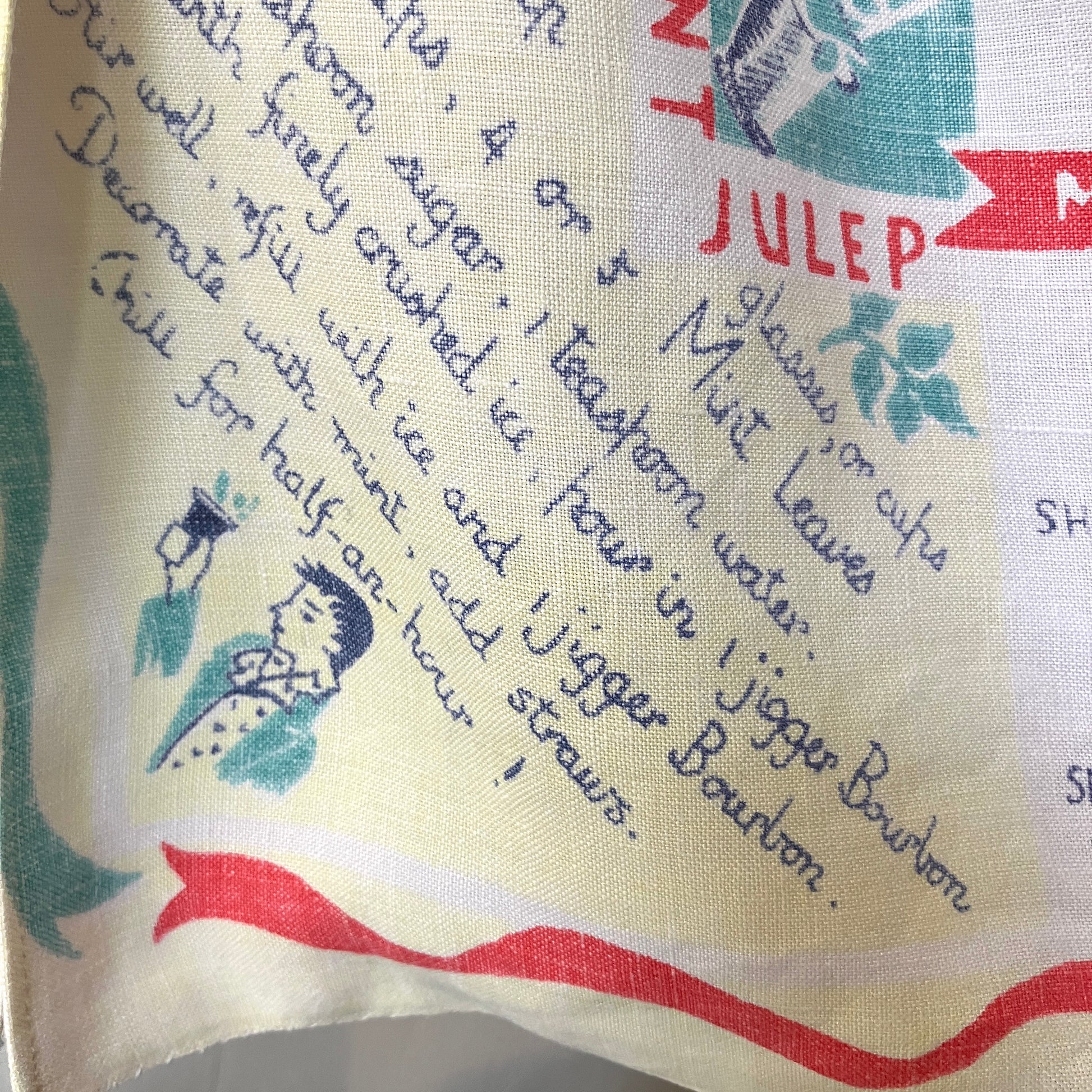 A shirt handmade from a vintage 'cocktails' tablecloth, featuring recipes and illustrations (close-up of recipe for Mint Julep)