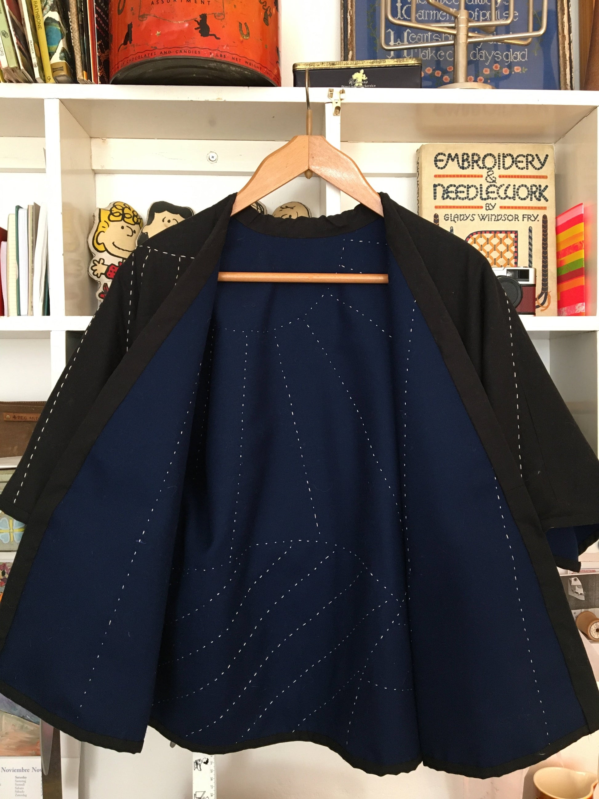 easy-fit quilted jacket with landscape and sunrays design hand quilted on the back, image shows the inside